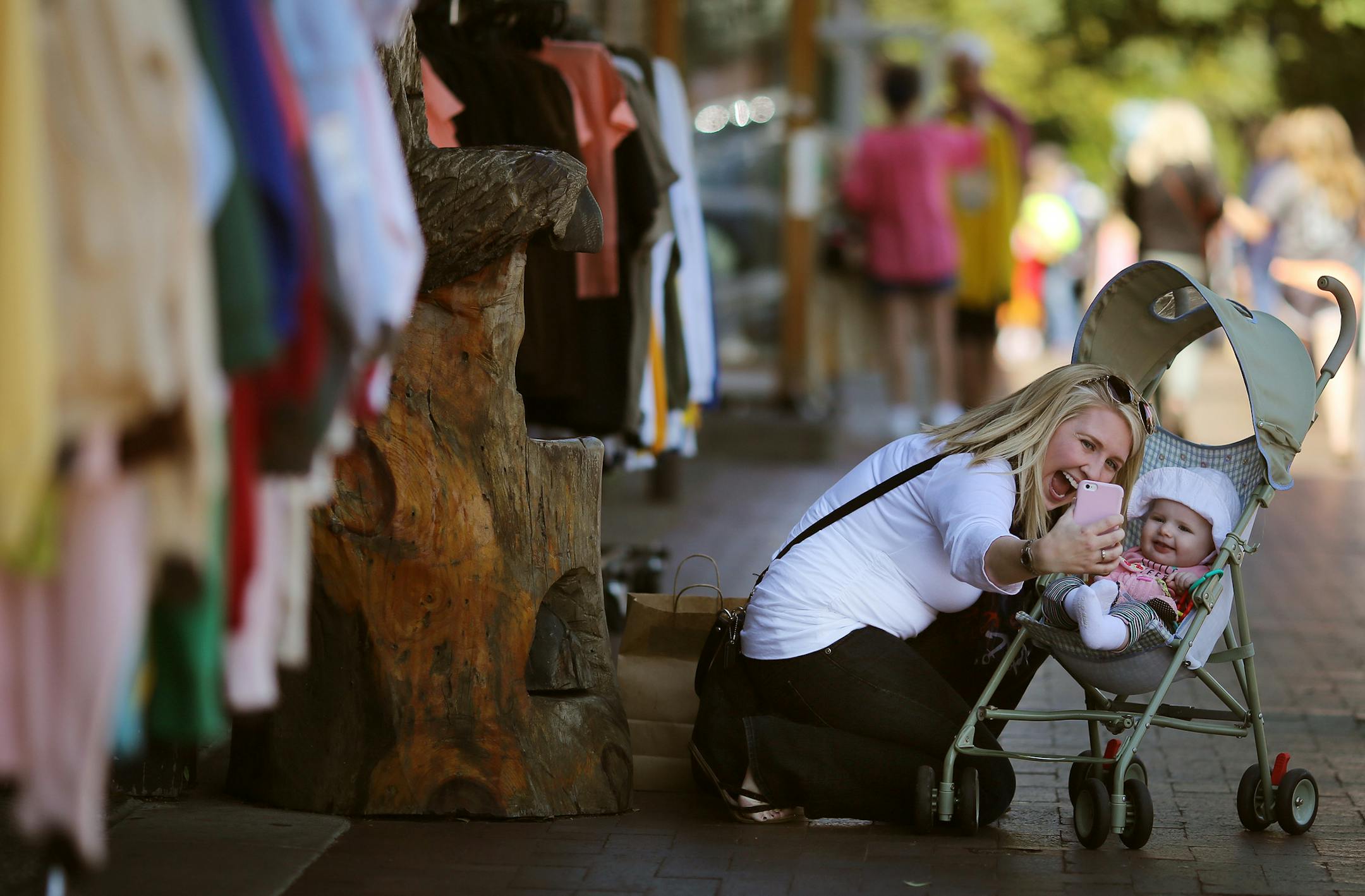Christina Nelson of Barnum, MN took a photo with her 9-month old daughter Olivia Nelson as she shopped on Canal Park Wednesday August 27 2015 in Duluth, MN. A profile on the resurgence of Duluth. ] Jerry Holt/ Jerry.Holt@Startribune.com