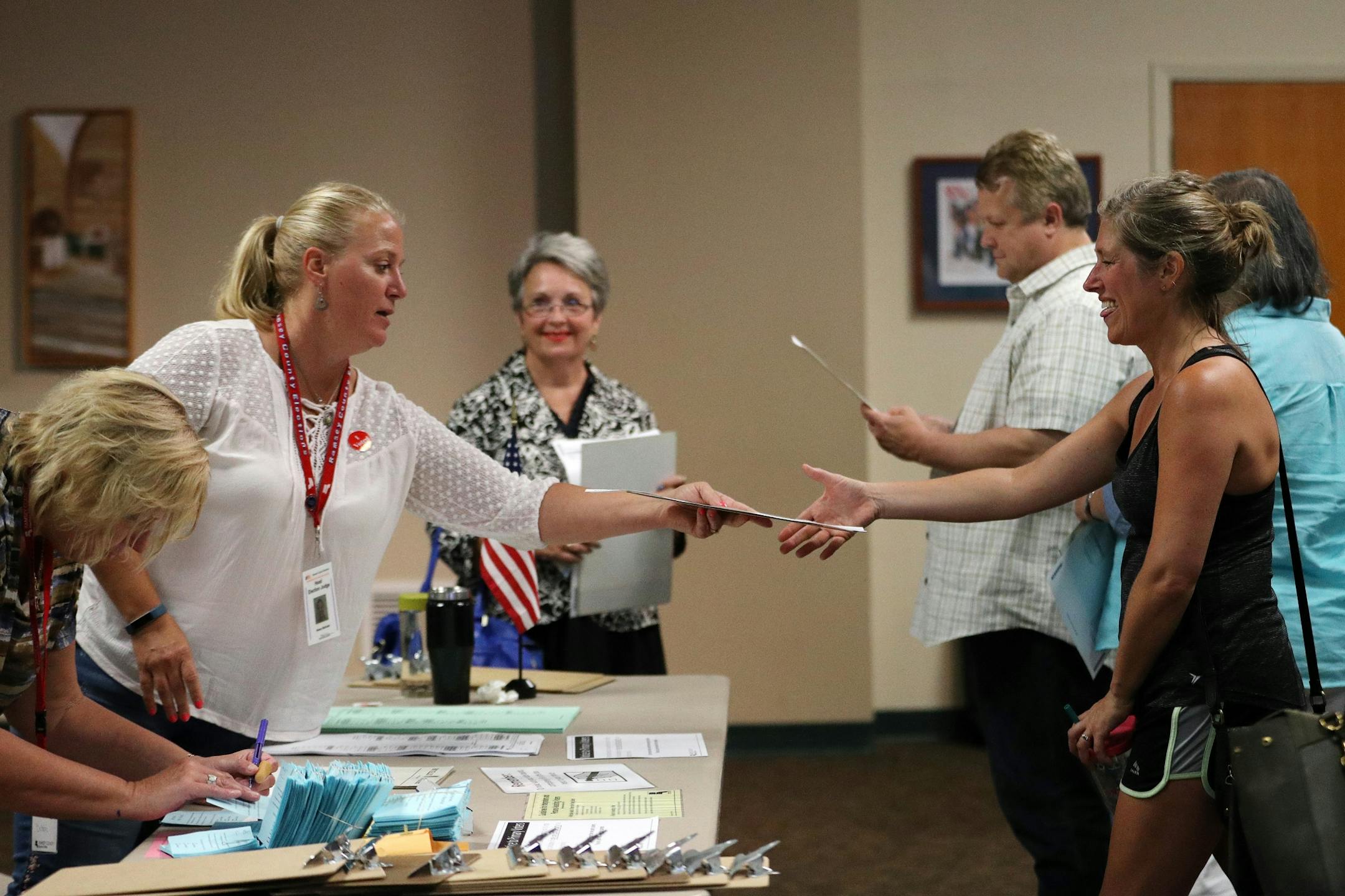 Head election judge Nancy McGrath explained the process to voters before they cast their ballots on primary election day at Holy Spirit Catholic Church in St. Paul.