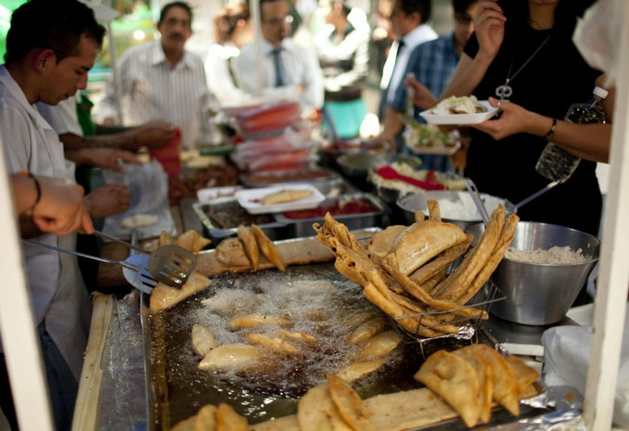 A street vendor fries food for customers during lunch time in Mexico City, Wednesday, July 10, 2013. Mexico has surpassed the United States in levels of adult obesity. Almost one-third of adult Mexicans, 32.8 percent, are obese compared to 31.8 percent of Americans, according to the U.N. Food and Agriculture Organization, or FAO.