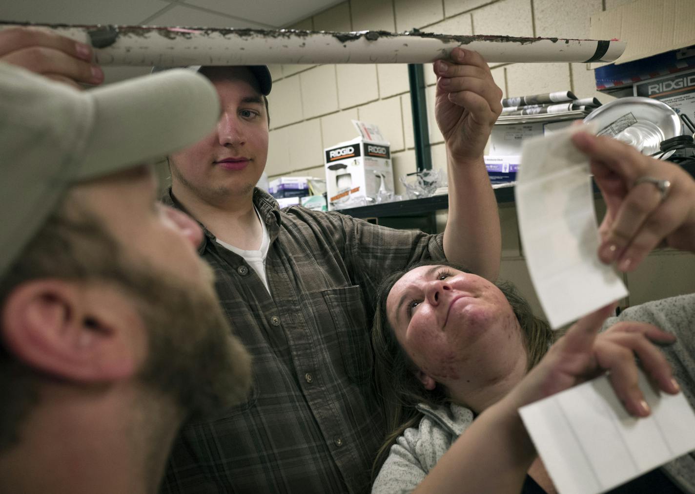 Nik Langevin held a core sample of mud, as Adam Krick left and Morgann Shanoff examined it at the Uof M Limnologiscal Research Center Thursday April 28, 2016 Minneapolis, MN.] Students from the University of Wisconsin-Superior spent the day a the University of Minnesota Limnological Research Center examining core samples of mud taken from lakes in northern Minnesota. Jerry Holt /Jerry.Holt@Startribune.com