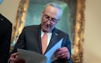 Senate Majority Leader Chuck Schumer, D-N.Y., looks over his notes during a meeting with Ukraine's Prime Minister Denys Shmyhal as Congress moves to a