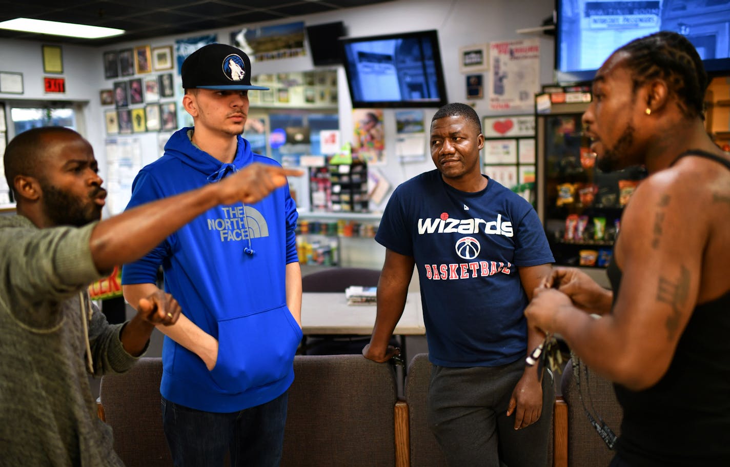 Sheku Samba, a member of the Brooklyn Center Multicultural Advisory Committee (MAC) came to Handz-on Barber shop to talk about police and the community in what was sometimes a heated discussion. L to R are James Wilson, Sean Anderson, Samba and Allen Hudson. ] GLEN STUBBE * gstubbe@startribune.com Thursday, November 10, 2016 A multi-cultural advisory committee established to enhance community policing measures is concerned about the fact that it has been unable to interest African-Americans in p