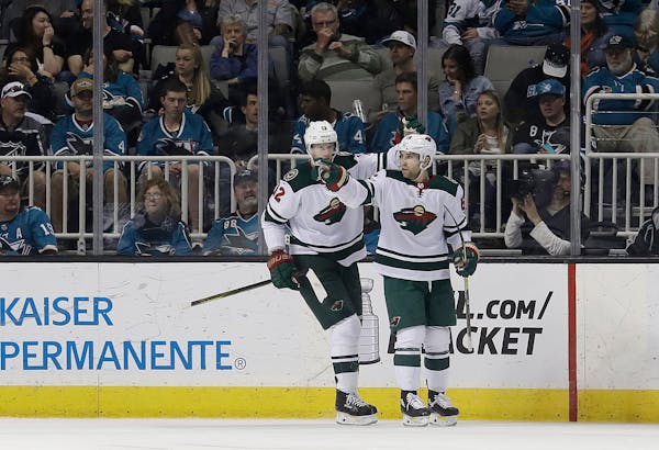 Wild left wing Jason Zucker, right, celebrates with Eric Staal after scoring a goal against the San Jose Sharks during the second period of Saturday's