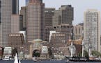 The USS Constitution glides through Boston Harbor past the city skyline on a cruise to honor Vietnam veterans, Friday, May 18, 2018, in Boston. The U.