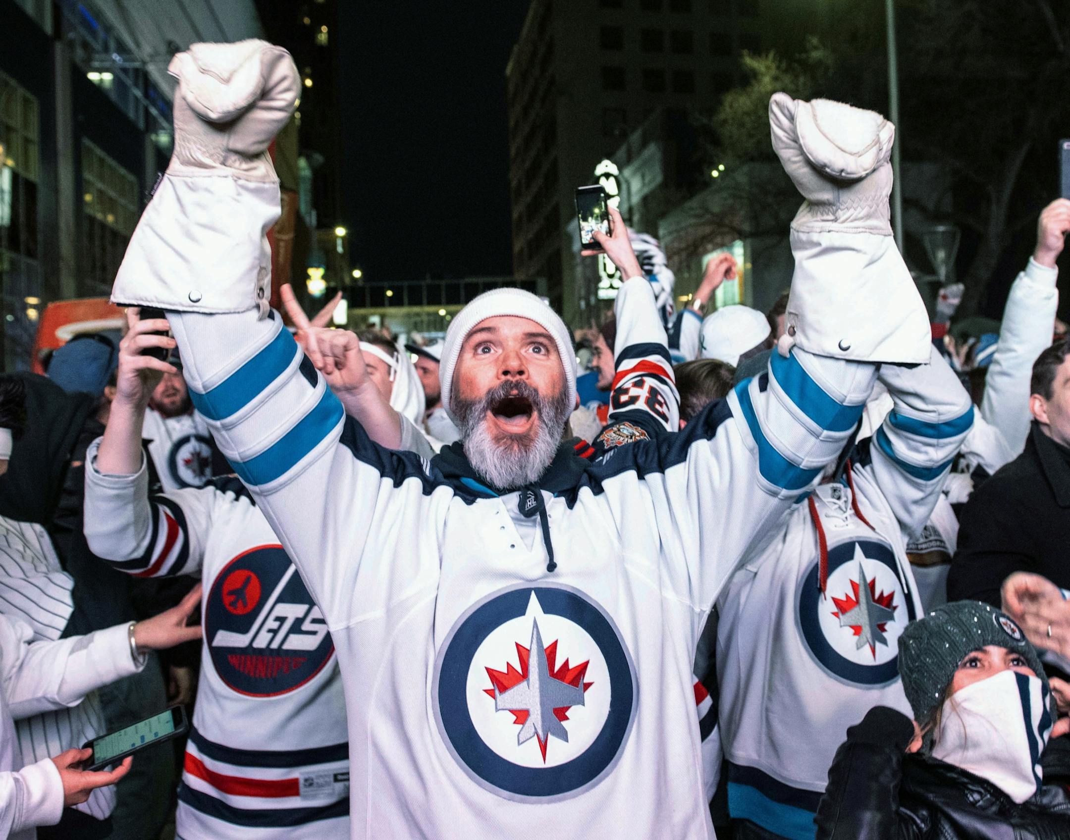 Winnipeg Jets fans at a viewing party celebrate the team's win over the Minnesota Wild in Game 1 in an NHL hockey first-round playoff series Wednesday, April 11, 2018, in Winnipeg, Manitoba.