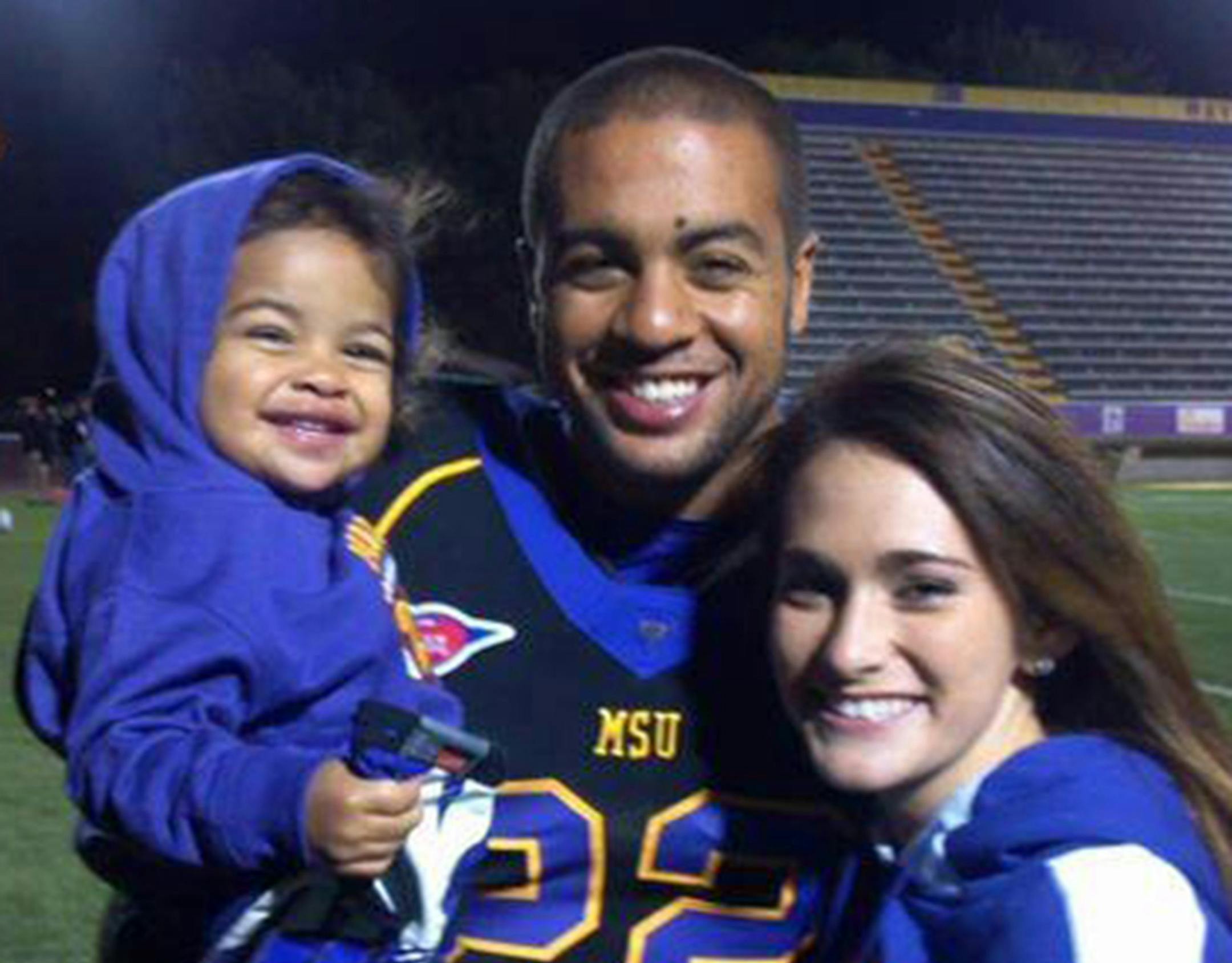 Isaac Kolstad is shown with his wife and one of his children.