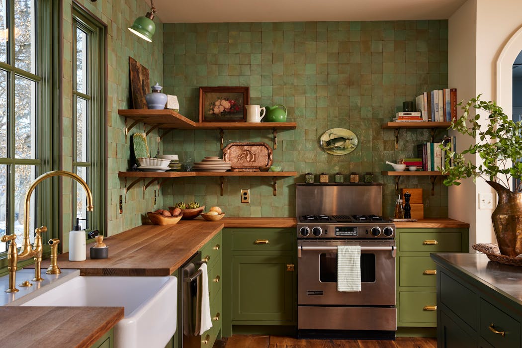 	Design-build firm MA Peterson dominated the kitchen with hues reminiscent of “green glass from an old bottle” to evoke the Old World English country charm the homeowners wanted.