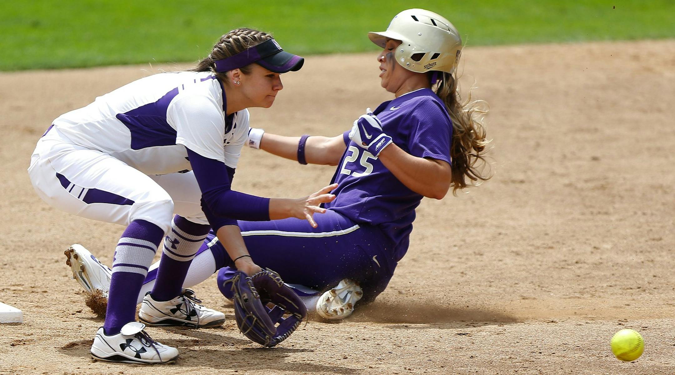Washington's Whitney Jones, right, beats the low throw from home to steal second as Northwestern's Anna Edwards steps off the plate to receive the ball in the fifth inning of an NCAA women's softball regional tournament game at the Husky Softball Stadium on Saturday, May 17, 2014, in Seattle. The Huskies won 9-0, advancing to their seventh consecutive Super Regionals appearance on head coach Heather Tarr's 400th win. (AP Photo/The Seattle Times, Lindsey Wasson) SEATTLE OUT; USA TODAY OUT; MAGS O