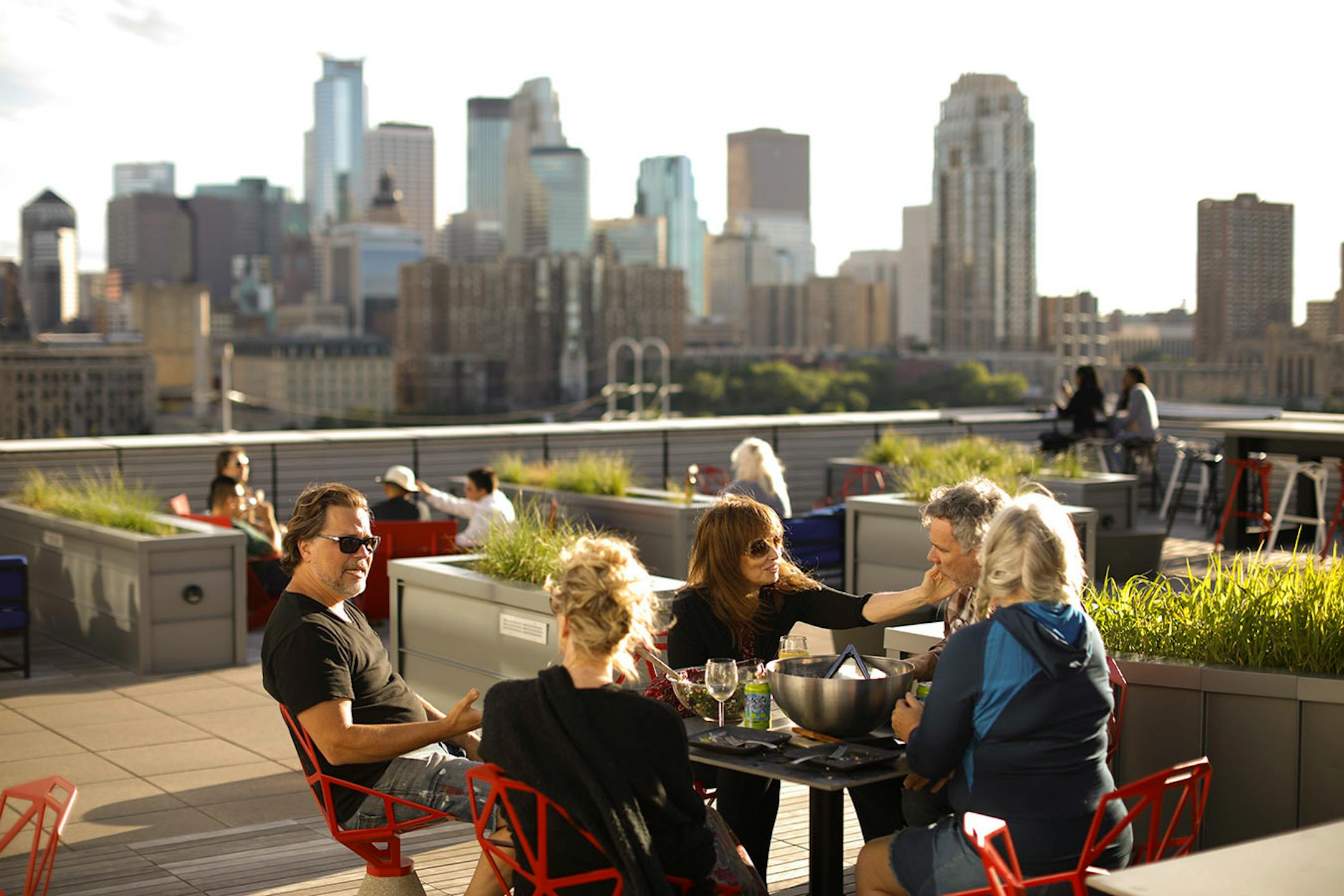 Daniel Rechelbacher, Laura Czarnecki, Phil Daniel, Mary Hanley, and Lisa Swan Gregori, clockwise from left, ate an al fresco dinner on the rooftop of the A-Mill Lofts, where Czarnecki and Daniel share a loft.