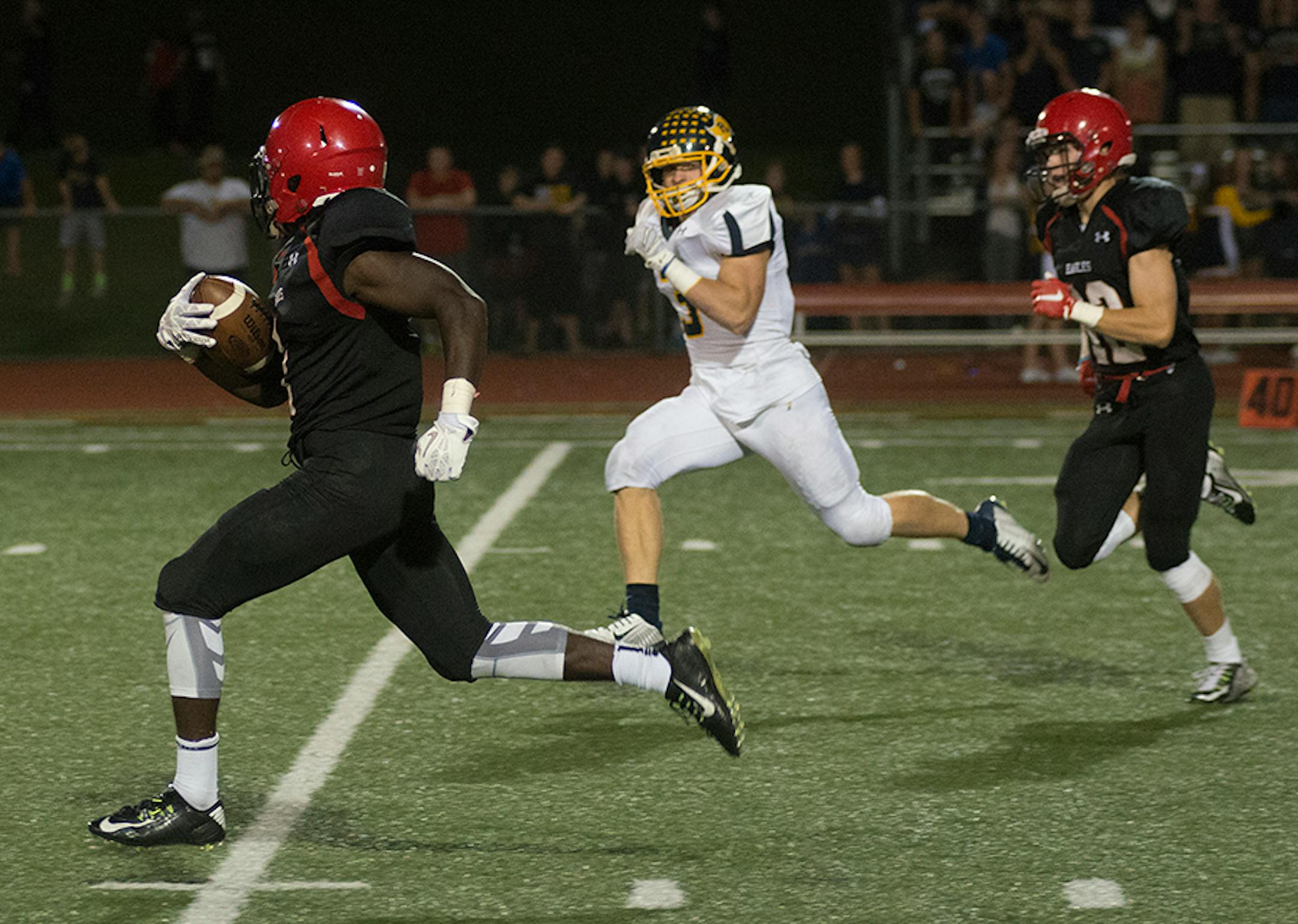 Eden Prairie's J.D Spielman takes it to the house to put EP up 30-15 over Prior Lake near the end of the first half of Friday night's game at Eden Prairie High School.