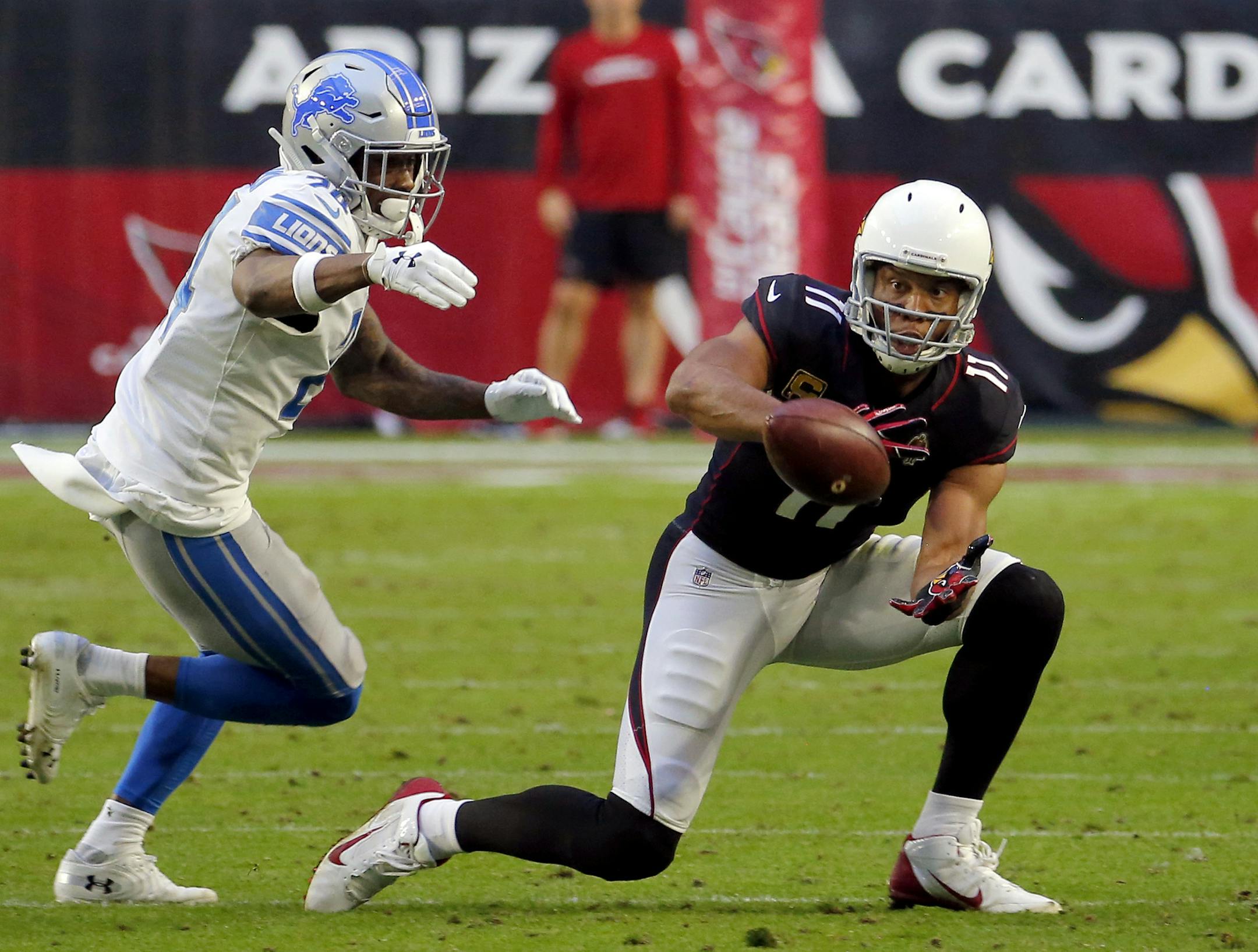FILE - In this Sunday, Dec. 9, 2018, file photo, Arizona Cardinals wide receiver Larry Fitzgerald (11) makes his 1,282nd career catch to surpass NFL Hall of Famer Jerry Rice for the most receptions with one team in NFL history during the second half of an NFL football game as Detroit Lions cornerback Nevin Lawson (24) defends in Glendale, Ariz. The Cardinals host the Los Angeles Rams on Sunday. (AP Photo/Rick Scuteri, File)