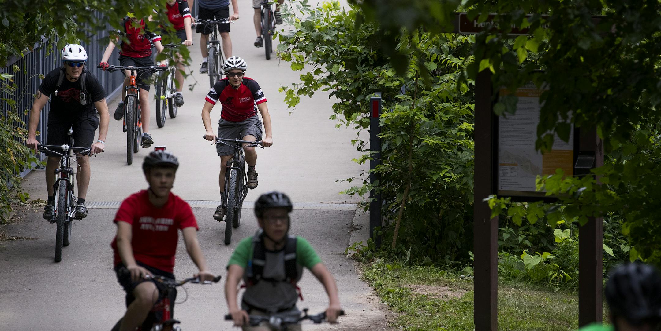 Shakopee High School Mountain Bike Team crossed a bridge on the Bloomington Ferry Unit trail. ] CARLOS GONZALEZ • cgonzalez@startribune.com - July 13, 2017, Bloomington, MN, Bloomington Ferry Unit, Shakopee High School Mountain Bike Team, Teagan Mason