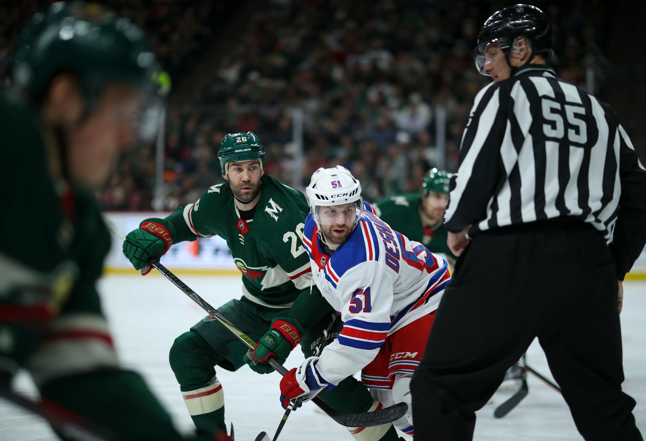 The Wild's Daniel Winnik and the Rangers' David Desharnais follow the puck after a second-period faceoff on Tuesday