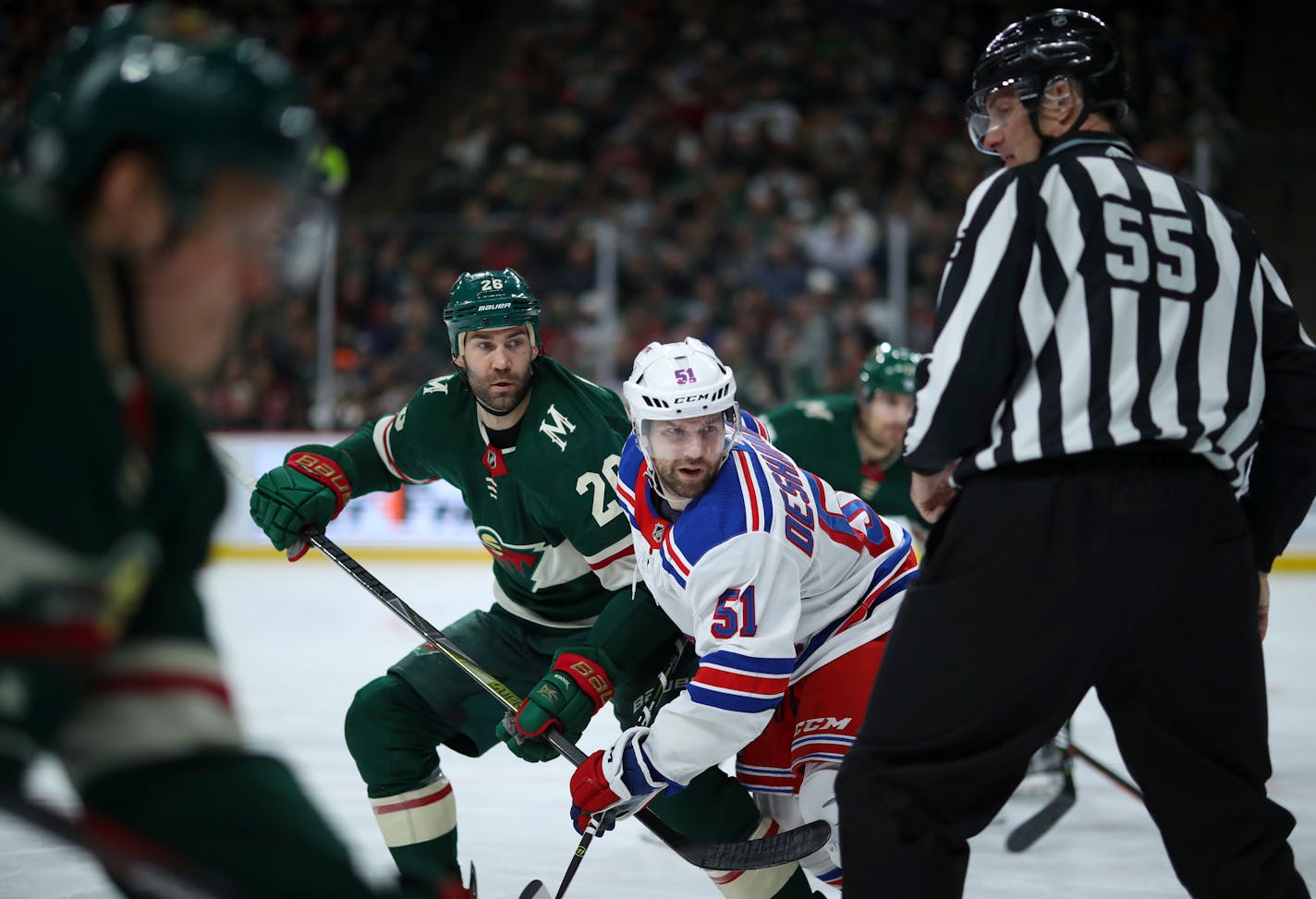 The Wild's Daniel Winnik and the Rangers' David Desharnais follow the puck after a second-period faceoff on Tuesday