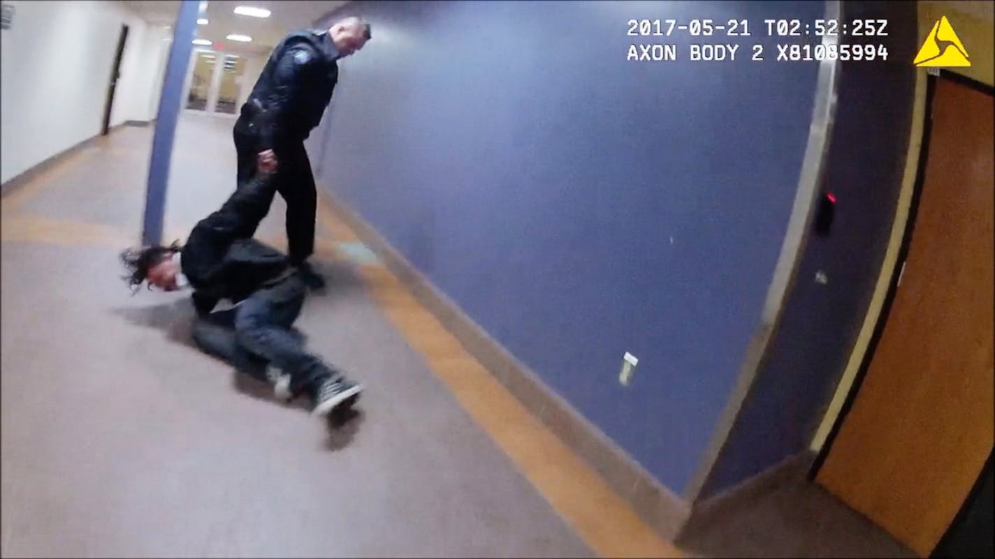 This screengrab from a Duluth police officer's body camera shows officer Adam Huot dragging a handcuffed man through the city's skywalk&#xd0;moments before his head struck a metal door. ORG XMIT: MIN1909031807495783