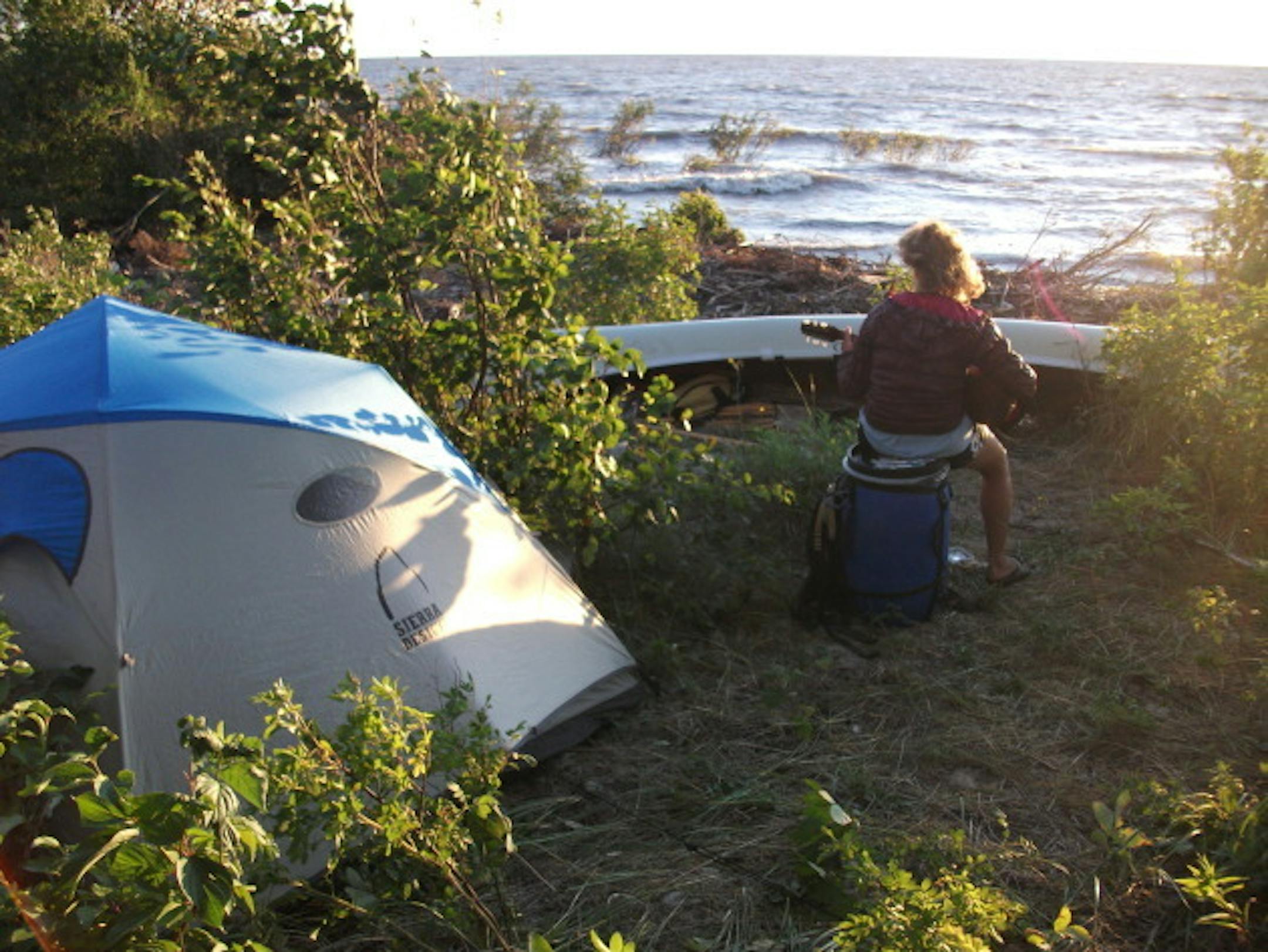 Ann Raiho looks out over Hudson Bay while strumming a tune
