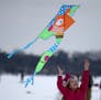 Lindsey Gunderson, 10, of Corcoran, let the wind catch her kite to watch it take off in the air over Lake Harriet. ] (KYNDELL HARKNESS/STAR TRIBUNE) k