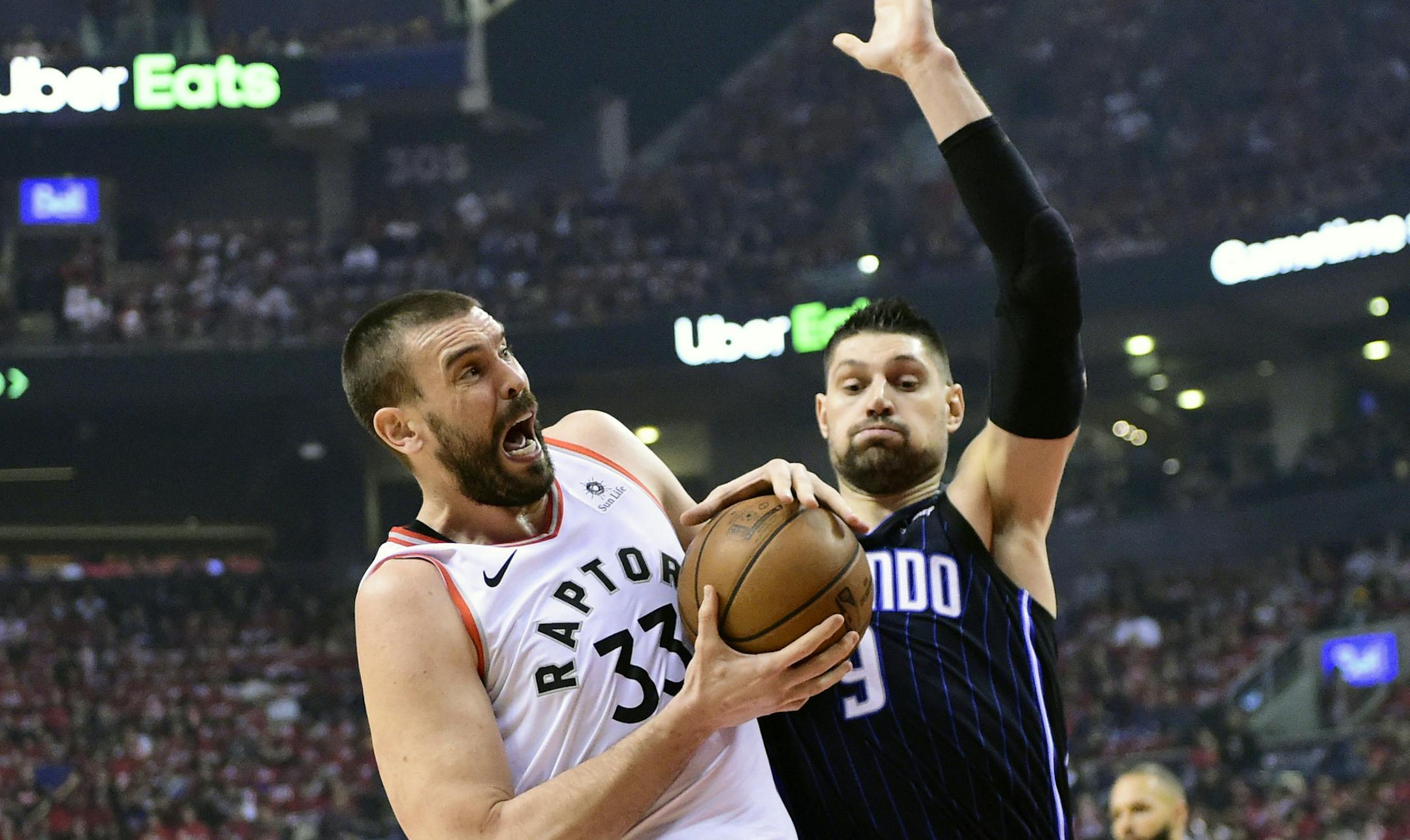 Toronto Raptors center Marc Gasol (33) battles Orlando Magic center Nikola Vucevic (9) for the ball during the first half in Game 5 of a first-round NBA basketball playoff series, Tuesday, April 23, 2019 in Toronto. (Frank Gunn/Canadian Press via AP)