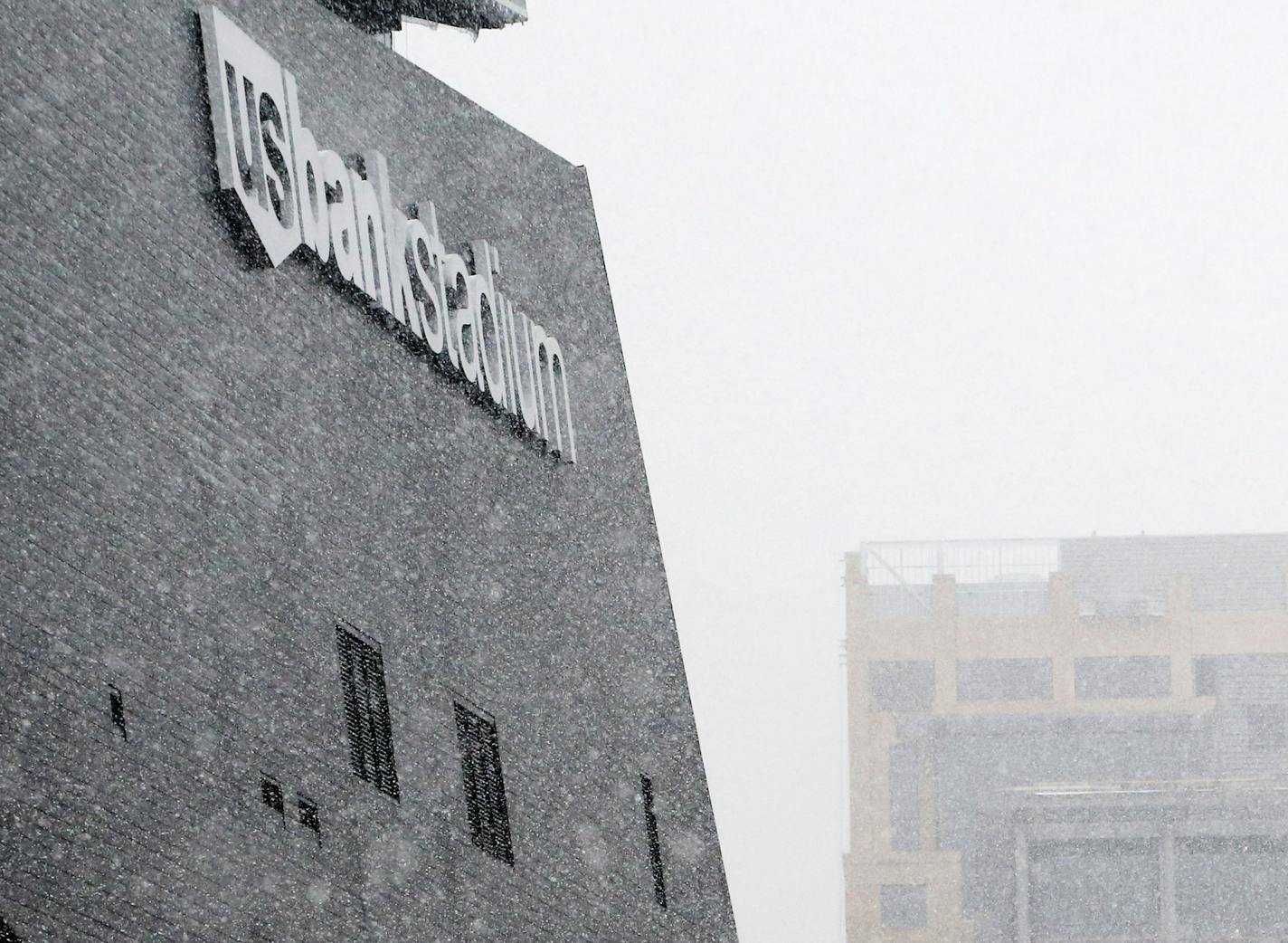 The U.S. Bank Stadium with the signage from the Wells Fargo towers to the north, seen from 11th Ave. S Wednesday, Dec. 23, 2015, in Minneapolis, MN.](DAVID JOLES/STARTRIBUNE)djoles@startribune.com Minnesota Vikings sue Wells Fargo saying the bank is putting up signs on its towers that are so big they will essentially "photo bomb" network shots during NFL games. Vikings seeking an emergency declaratory judgment to stop Wells Fargo.