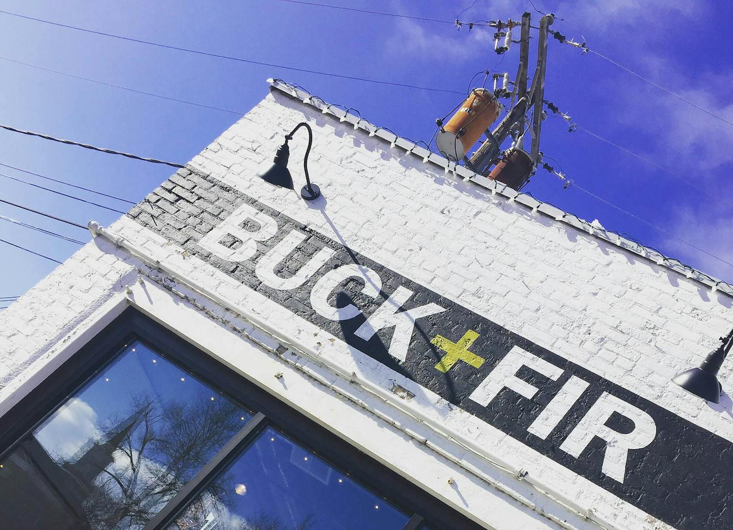 Hand painted sign by local artist Dusty Signs on new Buck + Fir boutique building, which is a converted garage located in the East Drive parking lot. Photo provided by Buck + Fir.