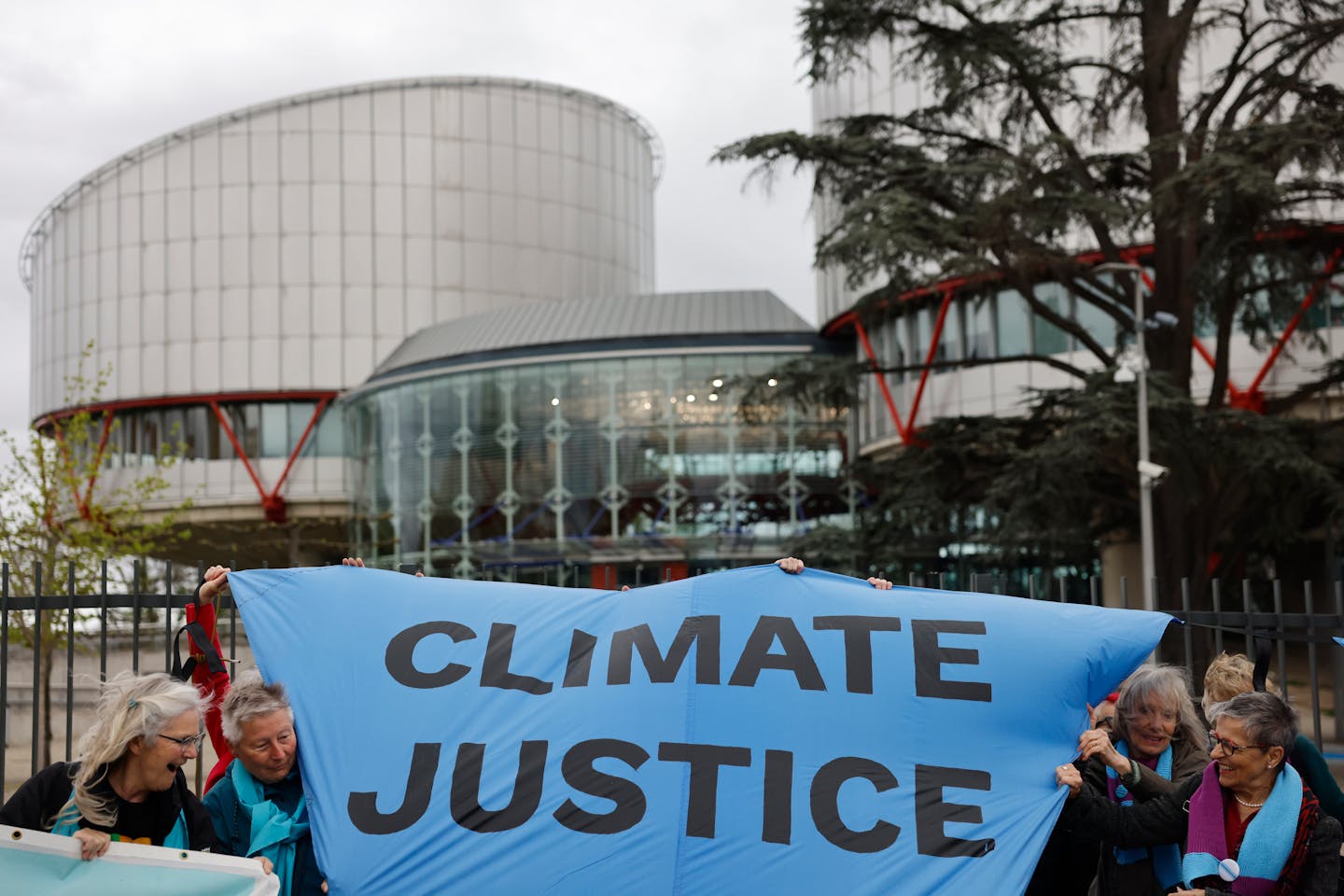 People demonstrate outside the European Court of Human Rights Tuesday, April 9, 2024 in Strasbourg, eastern France. Europe's highest human rights cour