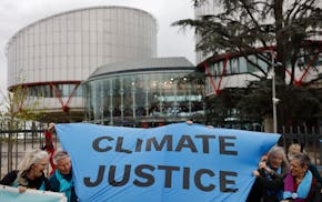 People demonstrate outside the European Court of Human Rights Tuesday, April 9, 2024 in Strasbourg, eastern France. Europe's highest human rights cour