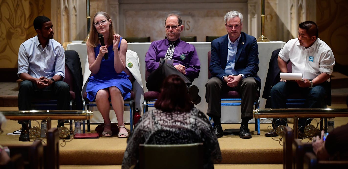 St. Paul mayoral candidates including, from left, Melvin Carter, Elizabeth Dickinson, Tom Goldstein, Pat Harris and Dai Thao, answered a question asked by Sumer Spika, bottom center, about their views on a $15 minimum wage during Tuesday night's mayoral forum. ] AARON LAVINSKY &#xef; aaron.lavinsky@startribune.com St. Paul's mayoral candidates faced off Tuesday night at the final forum before Saturday's DFL convention. The frontrunners tried to distinguish themselves from the pack at tonight's e