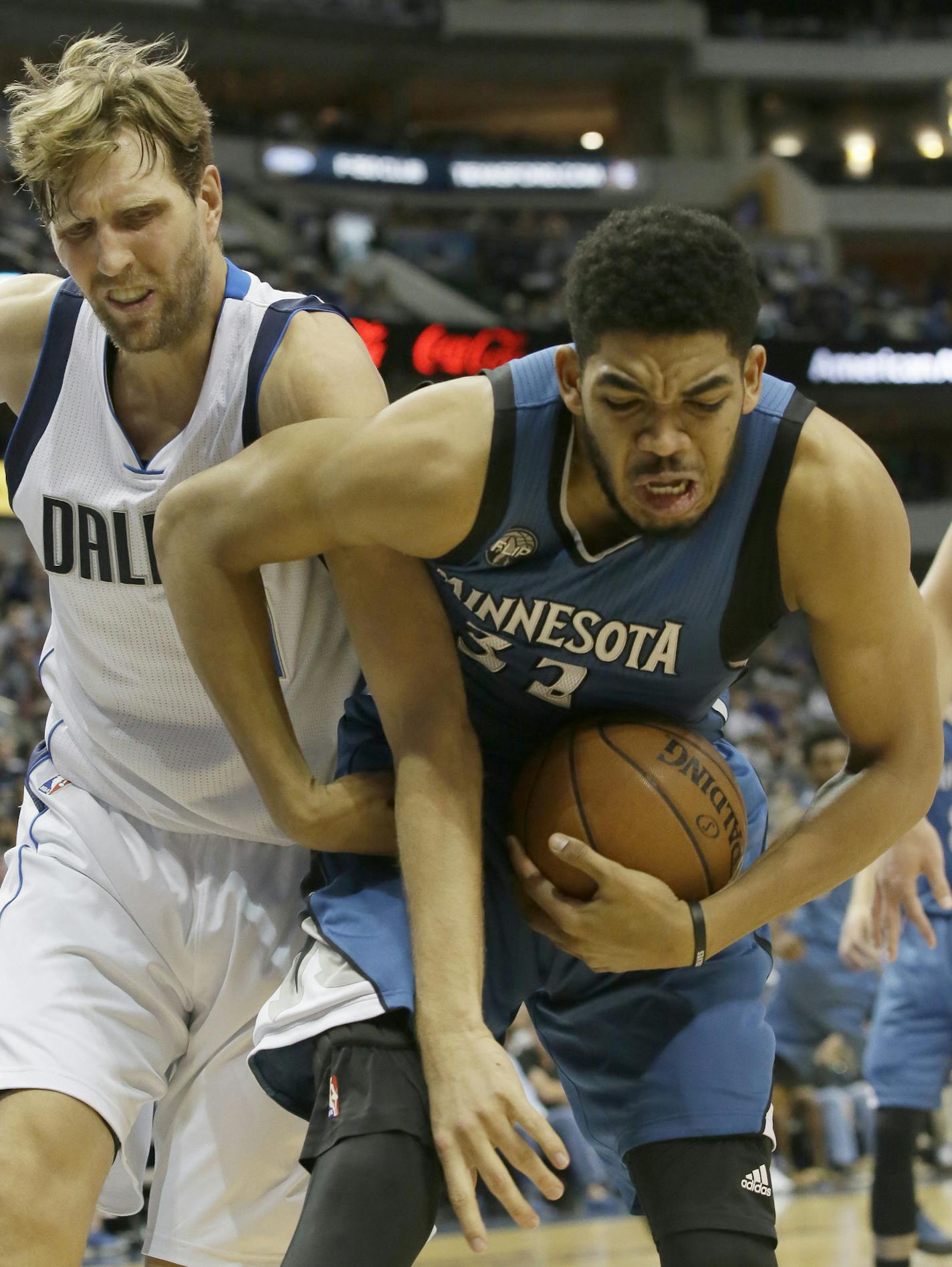 Minnesota Timberwolves center Karl-Anthony Towns (32) and Dallas Mavericks forward Dirk Nowitzki (41) battle for control of the ball during the first half of an NBA basketball game Sunday, Feb. 28, 2016, in Dallas. (AP Photo/LM Otero)