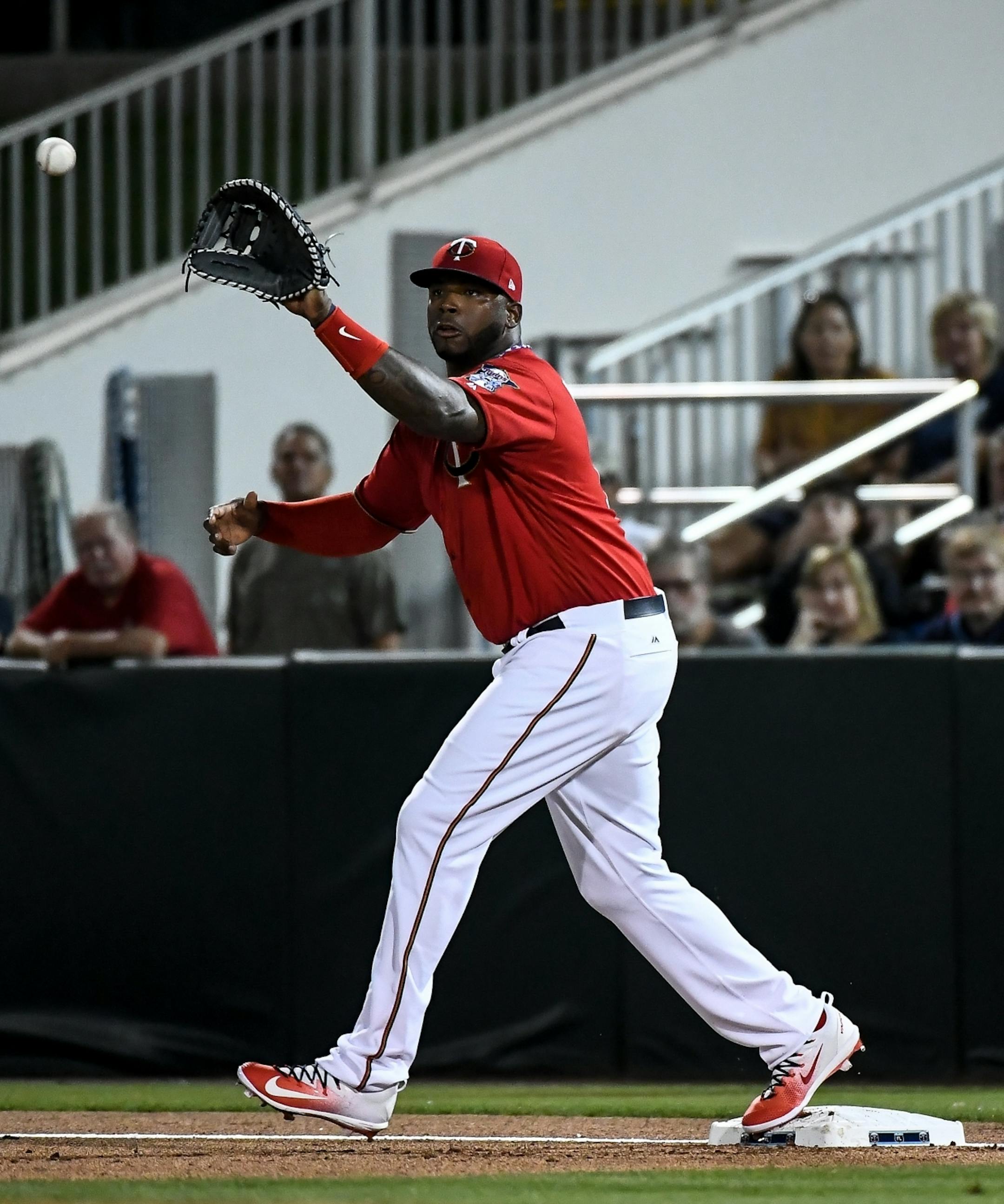 Minnesota Twins first baseman Kennys Vargas (19) caught a ball fielded by third baseman Miguel Sano (22) and hit by Tampa Bay left fielder Corey Dickerson for the out in the first inning Friday.