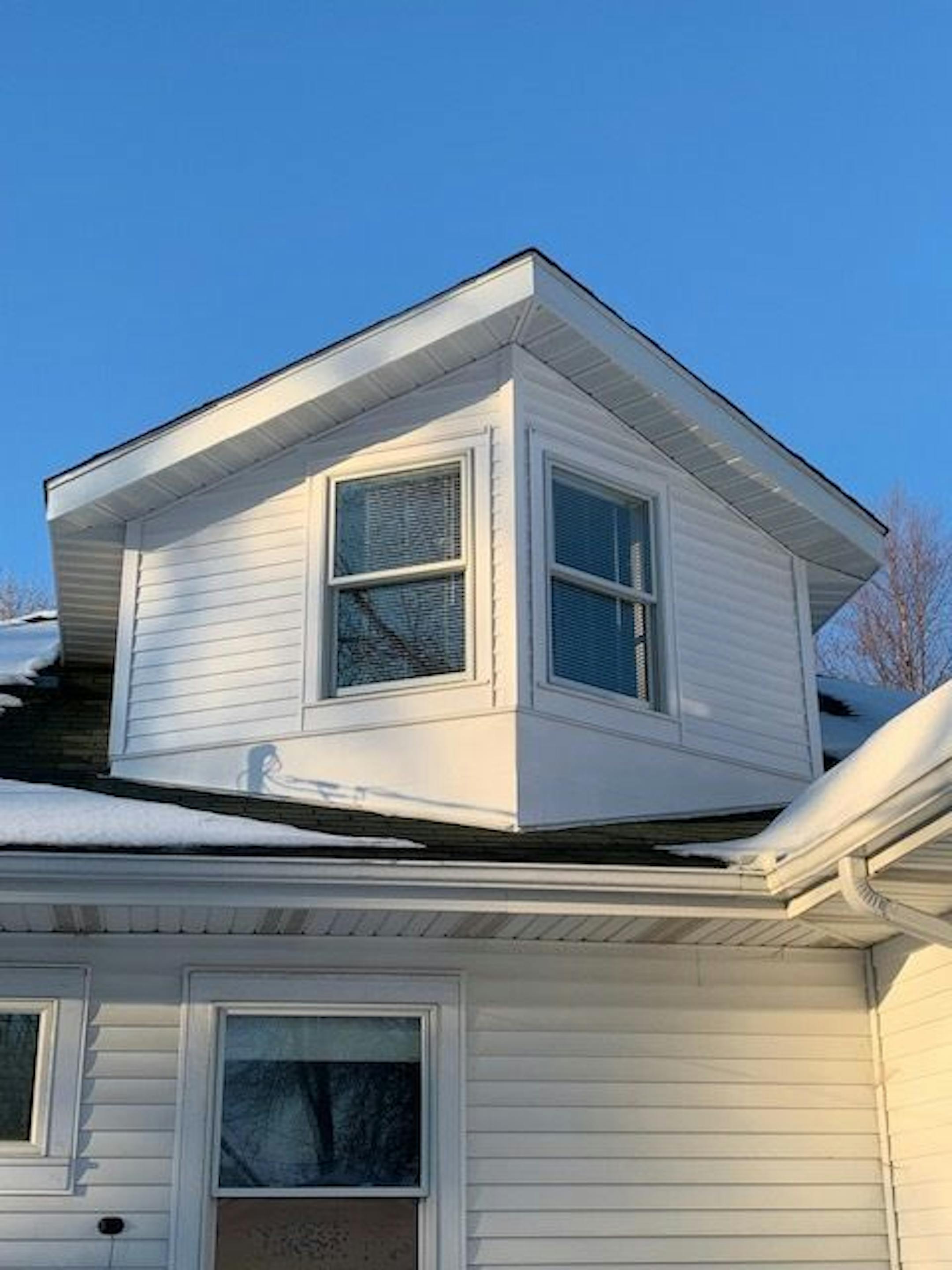 The gabled addition is only visible at the back of the house, not from the street.
