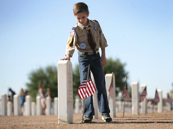 May 2011: A Boy Scout at Ft. Bliss National Cemetery after placing a flag in preparation for Memorial Day.