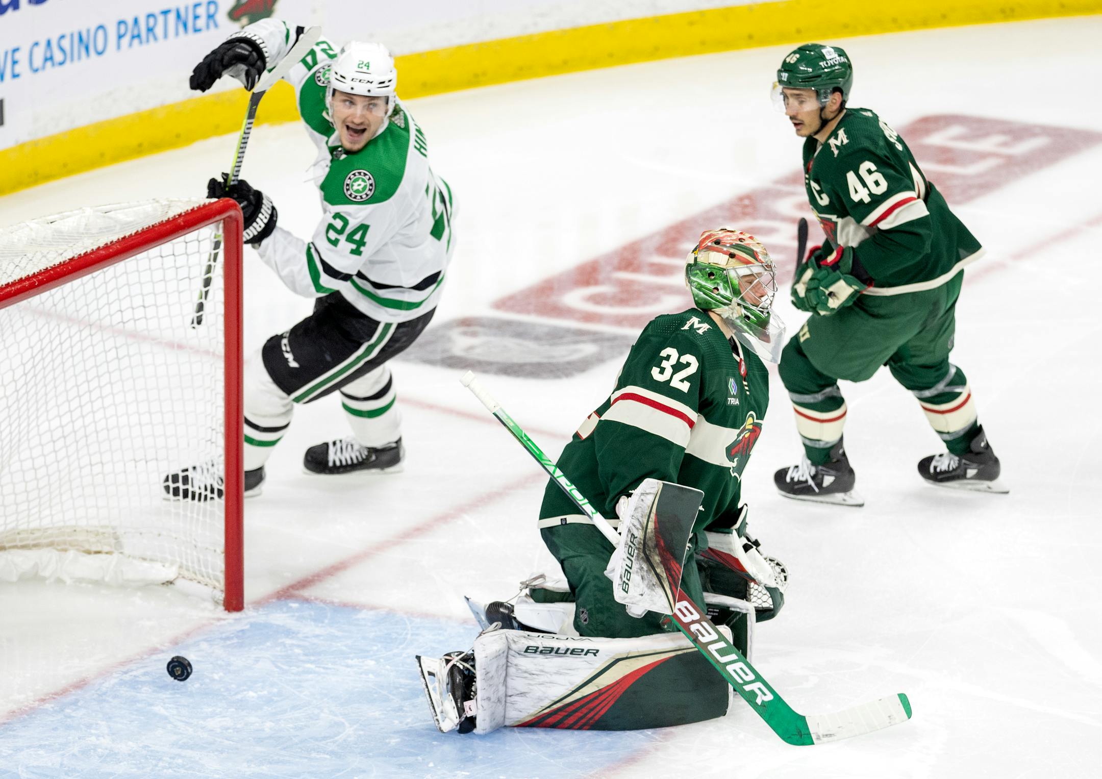 Roope Hintz (24) of the Dallas Stars celebrates a goal by Evgenii Dadonov next to Wild goalie Filip Gustavsson in the third period.