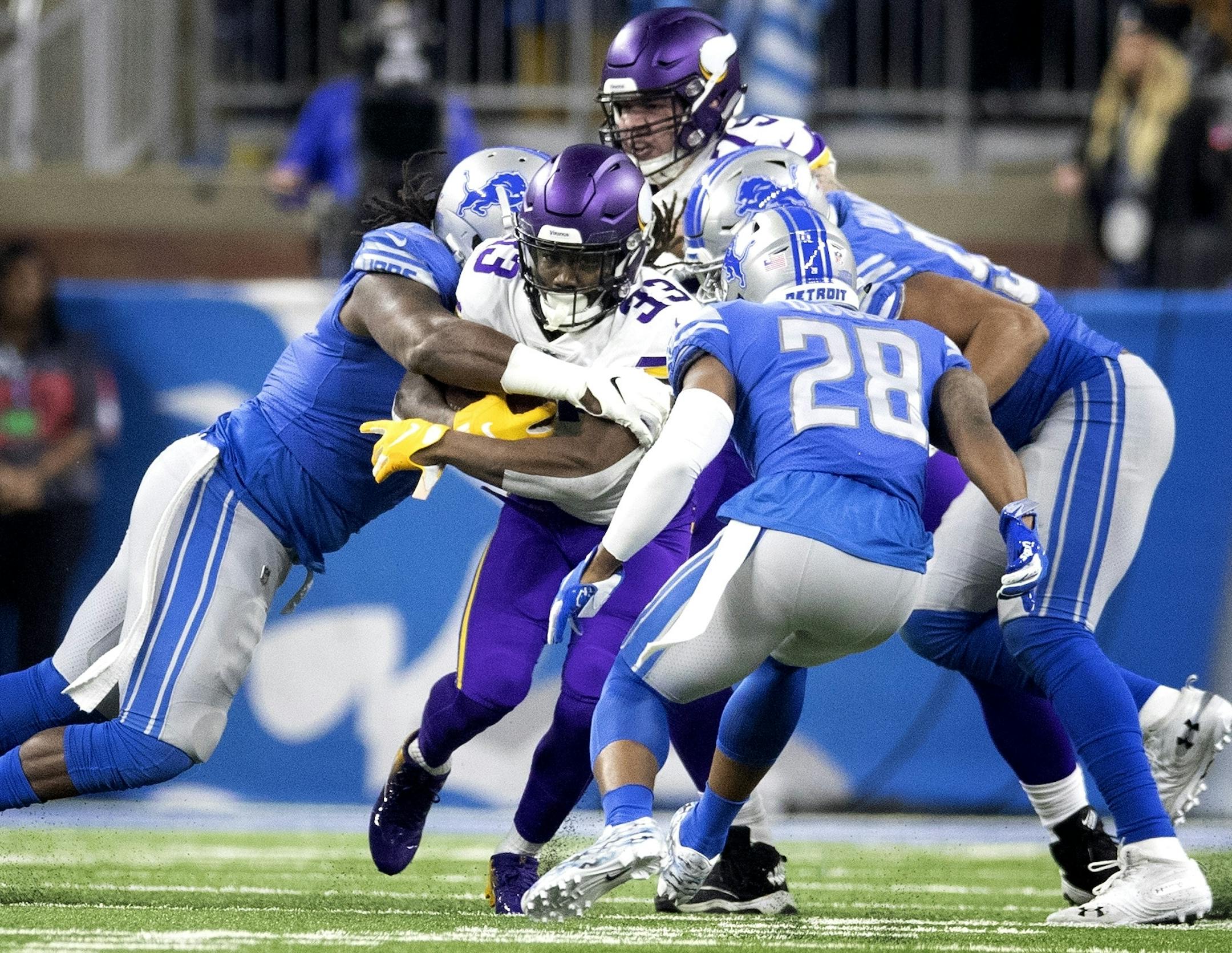 Lions defenders stopped Minnesota Vikings running back Dalvin Cook (33) for know gain in the second quarter at Ford Field Sunday December 23, 2018 in Detroit, MI.