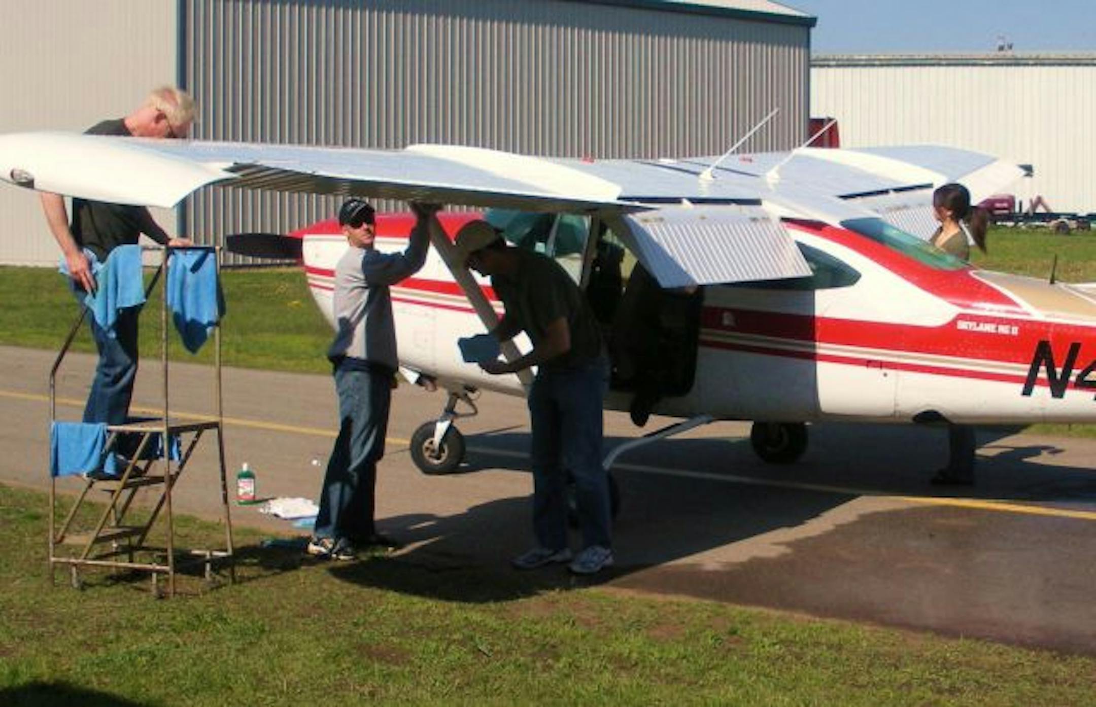 From left, club members Marlan Perhus (FAA inspector), Steve Guetter (aerospace executive), Bernie O'Brien (chiropractor) and Karen Gentry (flight attendant) gave the Cessna 182RG its semi-annual wash and wax.