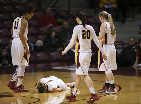 Gophers guard Rachel Banham (1), on the floor, left the game with an injury midway through the second half.