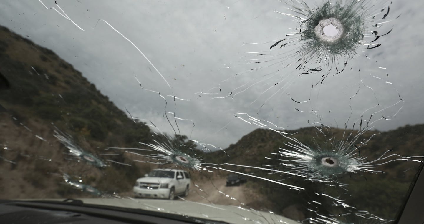 Bullet-riddled vehicles that members of LeBaron family were traveling in sit parked on a dirt road near Bavispe, at the Sonora-Chihuahua border, Mexico, Wednesday, Nov 6, 2019. Three women and six of their children, related to the extended LeBaron family, were gunned down in an attack while traveling along Mexico's Chihuahua and Sonora state border on Monday. (AP Photo/Christian Chavez)