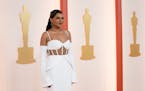 Mindy Kaling played peekaboo in her Vera Wang  that had a structured peplum ruffle on the hip. The attached sleeve added a modern look.