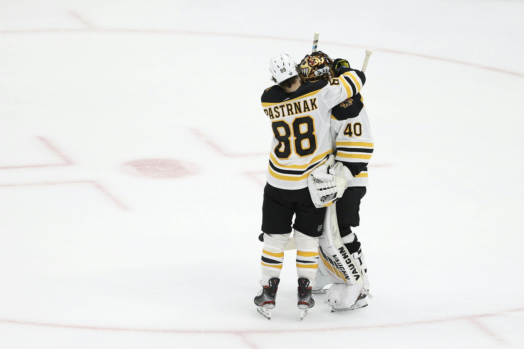 Boston Bruins right wing David Pastrnak (88), of the Czech Republic, celebrates with goaltender Tuukka Rask, of Finland, after the Bruins beat the St. Louis Blues in Game 6 of the NHL hockey Stanley Cup Final Sunday, June 9, 2019, in St. Louis. The Bruins won 5-1 to even the series 3-3. (AP Photo/Scott Kane)