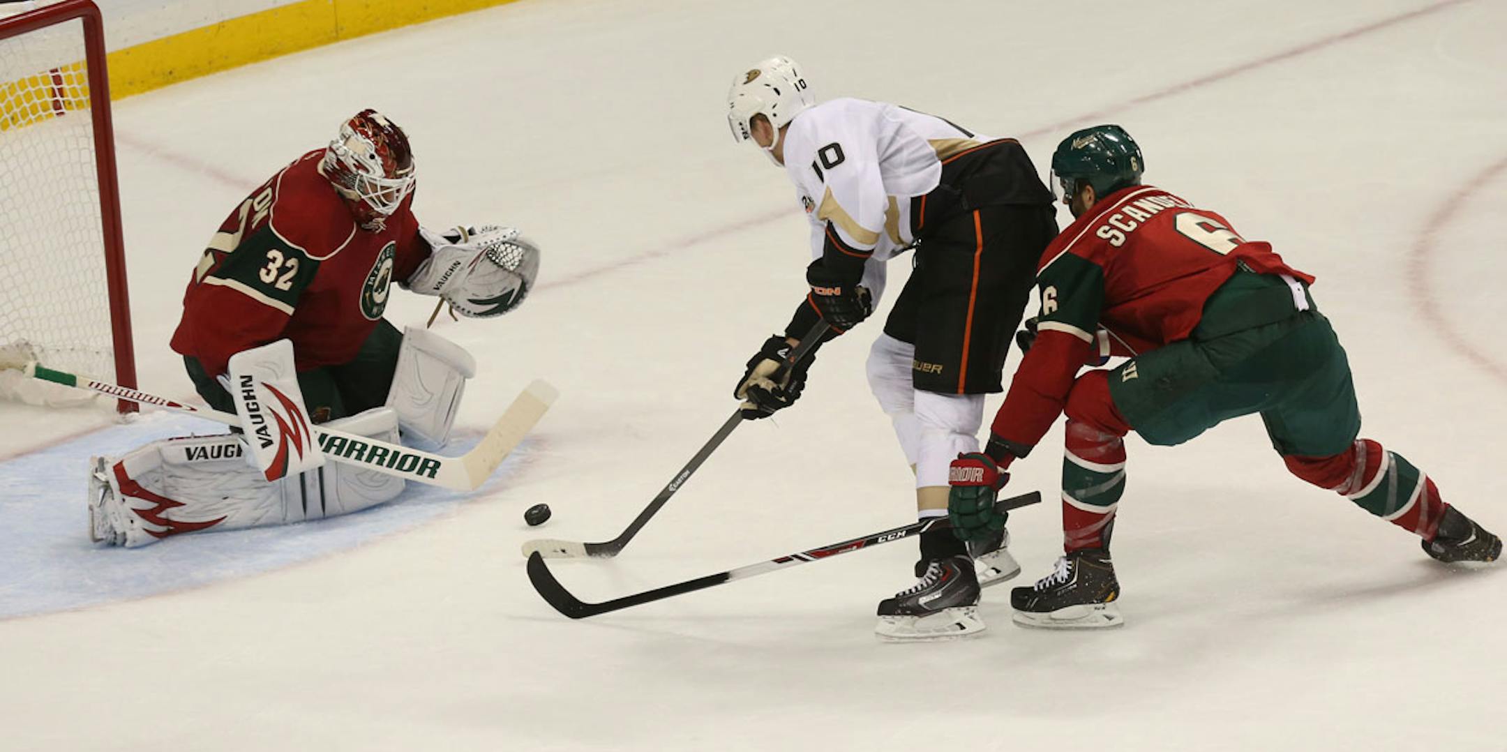 Corey Perry tried to score on Wild goalie Niklas Backstron with Marco Scandella defending during the second period at Xcel Energy Center in St. Paul on October 5, 2013.