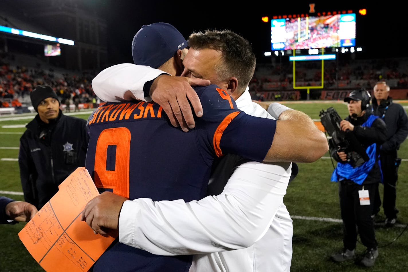 Illinois head coach Bret Bielema hugs quarterback Artur Sitkowski after the team's 9-6 win over Iowa in an NCAA college football game Saturday, Oct. 8, 2022, in Champaign, Ill. (AP Photo/Charles Rex Arbogast)