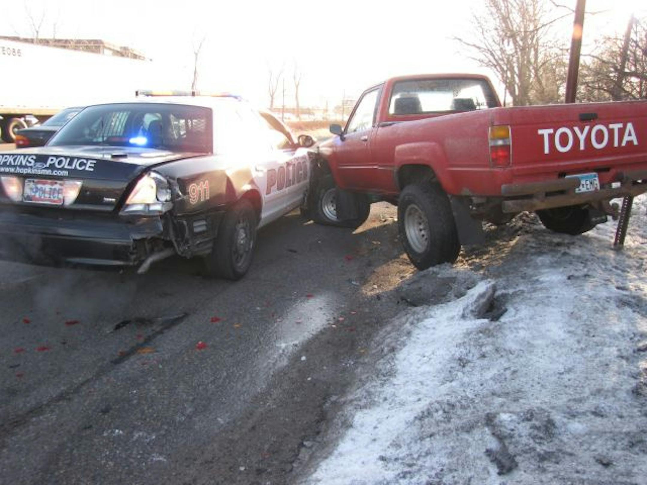 A pickup truck with a frosted-over windshield rear-ended a Hopkins police car making a traffic stop Monday morning, slightly injuring the two officers in their vehicle, authorities said. Squad damage is estimated at around $10,000.00.