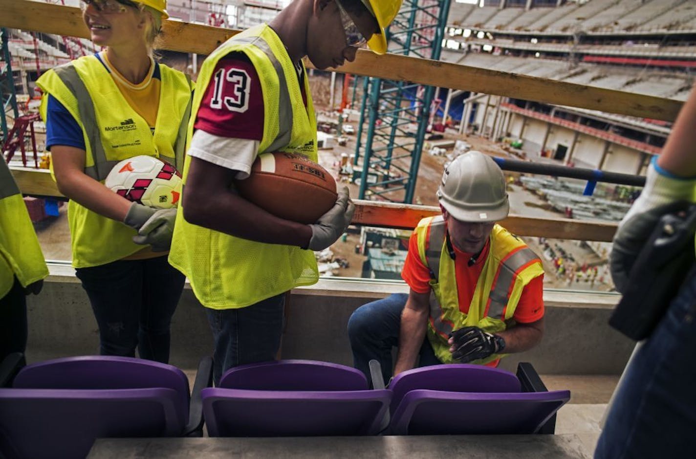 At the new Vikings stadium, a group of high school athletes including Bailee Hyde of Wayzata, left, and Jacques Lyles of Central in St. Paul, got an opportunity to view some of the first purple seats being installed as well as the progress being made.