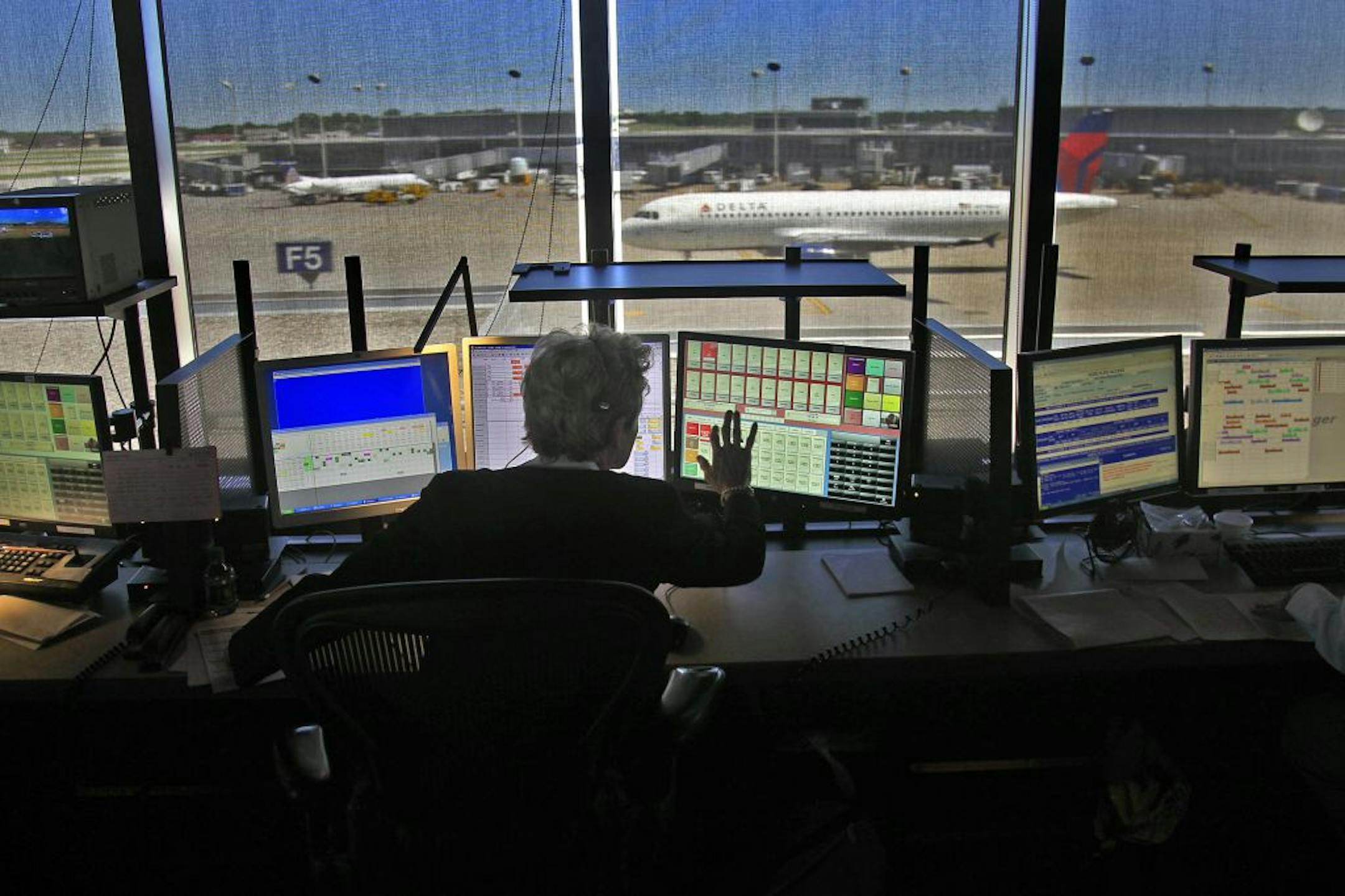 Agent Kim Arenberg has a workspace with a view at Delta's airport control center. The center's staff coordinates communication with a host of airline workers.