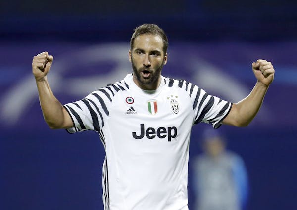 Juventus's Gonzalo Higuain celebrates after team mate Miralem Pjanic scored his side's first goal during the Champions League Group H soccer match bet