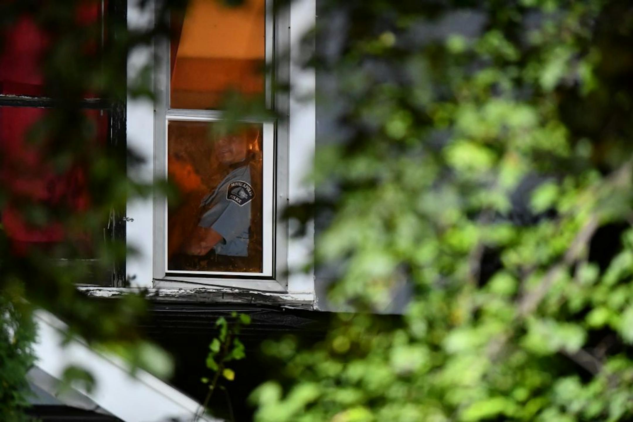 A Minneapolis police officer looks out the window of a housing unit where a 4-year old girl was killed in a domestic assault Saturday night.