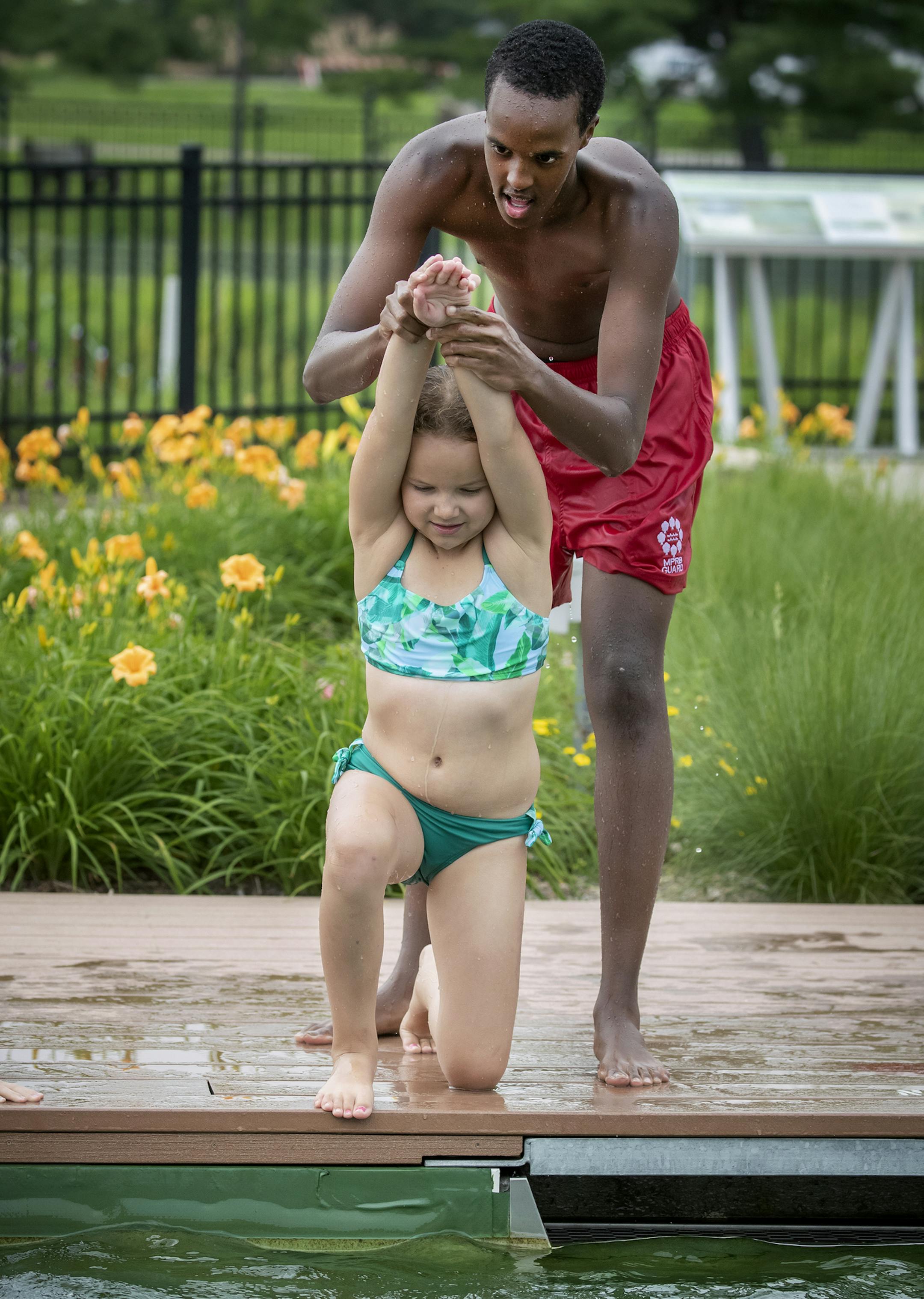 Webber Pool lifeguard Mohamed Mohamed, cq, gave swimming lessons to Nadia Cross, 8, along with other children at the pool, Tuesday, July 9, 2019 in Minneapolis, MN. The Hennepin County Sheriff's Office (HCSO) has partnered with the Minneapolis Parks and Recreation Board to offer low-cost swimming lessons to those who need to learn to swim but cannot afford lessons. ] ELIZABETH FLORES • liz.flores@startribune.com