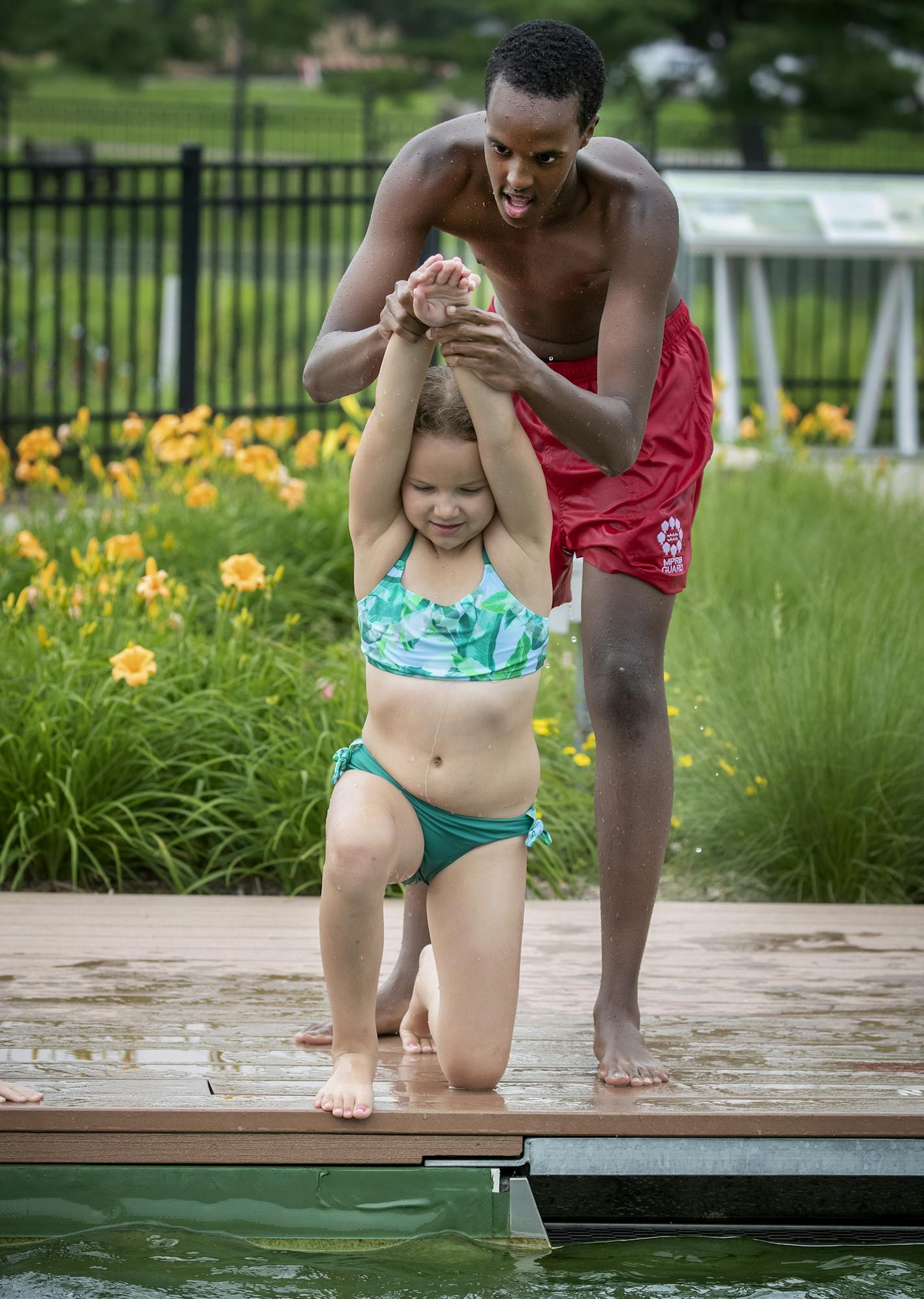 Webber Pool lifeguard Mohamed Mohamed, cq, gave swimming lessons to Nadia Cross, 8, along with other children at the pool, Tuesday, July 9, 2019 in Minneapolis, MN. The Hennepin County Sheriff's Office (HCSO) has partnered with the Minneapolis Parks and Recreation Board to offer low-cost swimming lessons to those who need to learn to swim but cannot afford lessons. ] ELIZABETH FLORES &#x2022; liz.flores@startribune.com