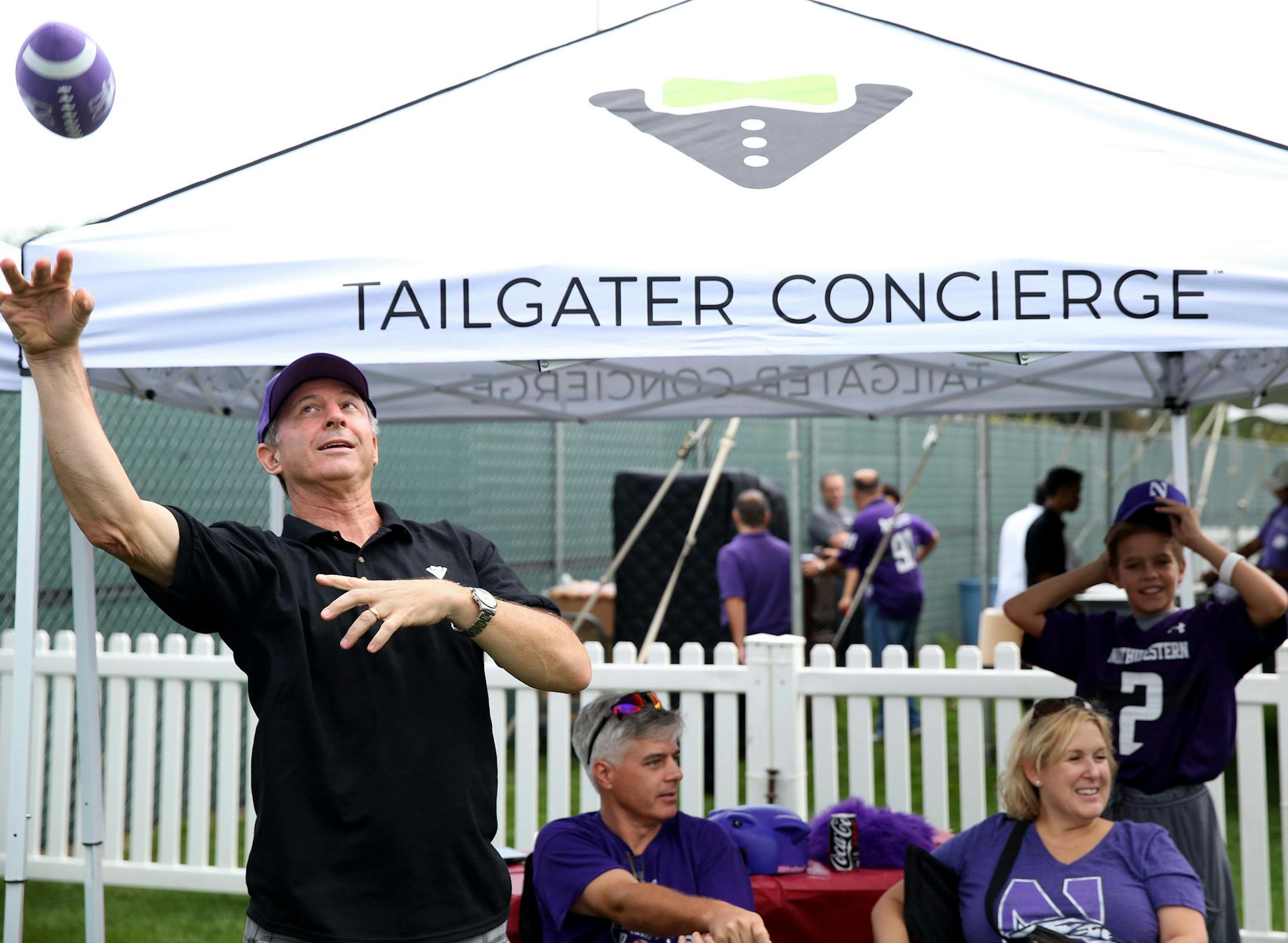 Neil Golden tosses a football with kids while promoting his business, Tailgater Concierge, outside of Northwestern's Ryan Field before a football game against Stanford on Sept. 5, 2015 in Evanston, Ill. (Chris Sweda/Chicago Tribune/TNS) ORG XMIT: 1173647