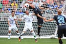 Minnesota United FC forward Christian Ramirez (21) was unable to score off a corner kick while being defended by Club Leon's Miguel Ibarra in the firs