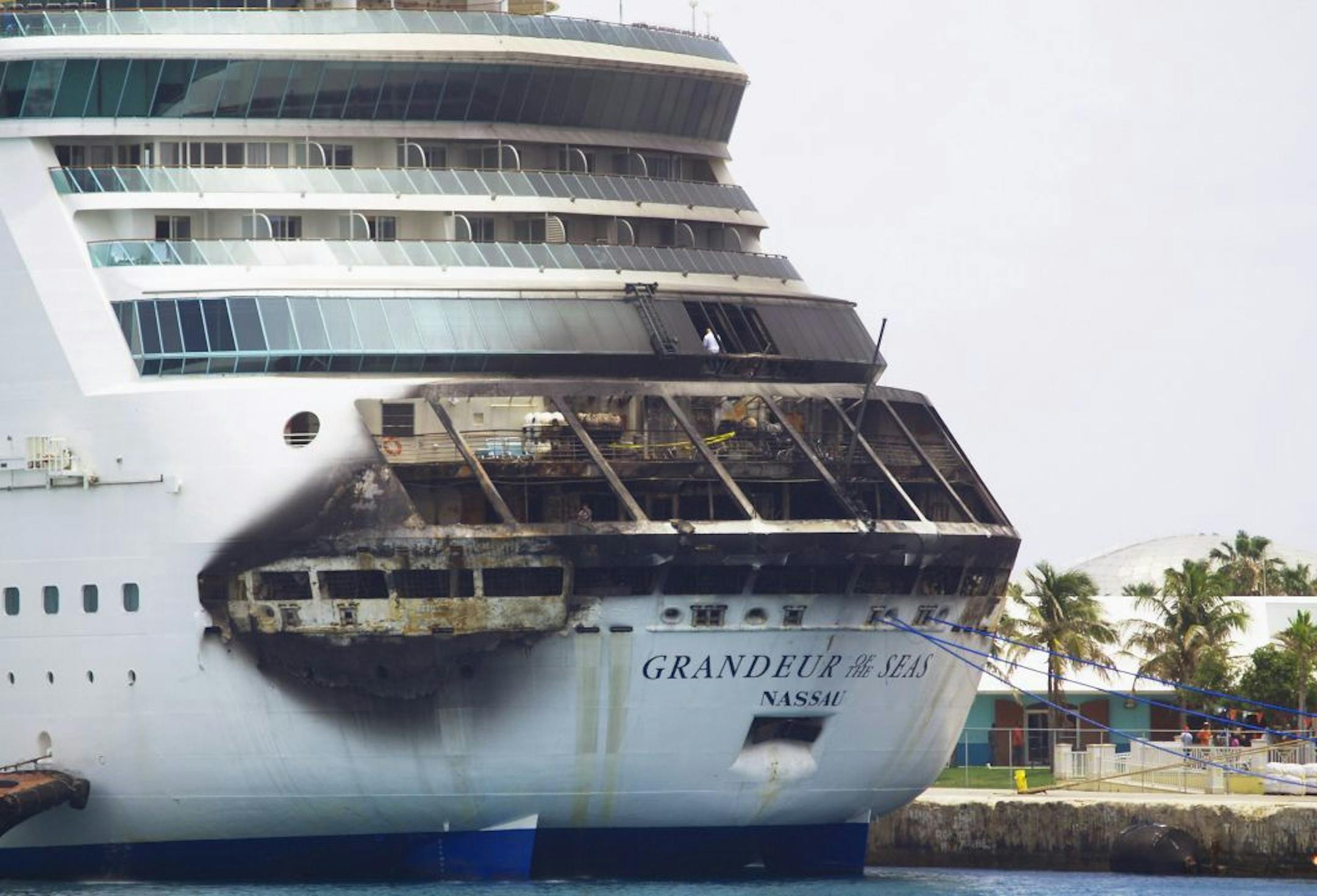 The fire-damaged exterior of Royal Caribbean's Grandeur of the Seas cruise ship is seen while docked in Freeport, Grand Bahama island, Monday, May 27, 2013.